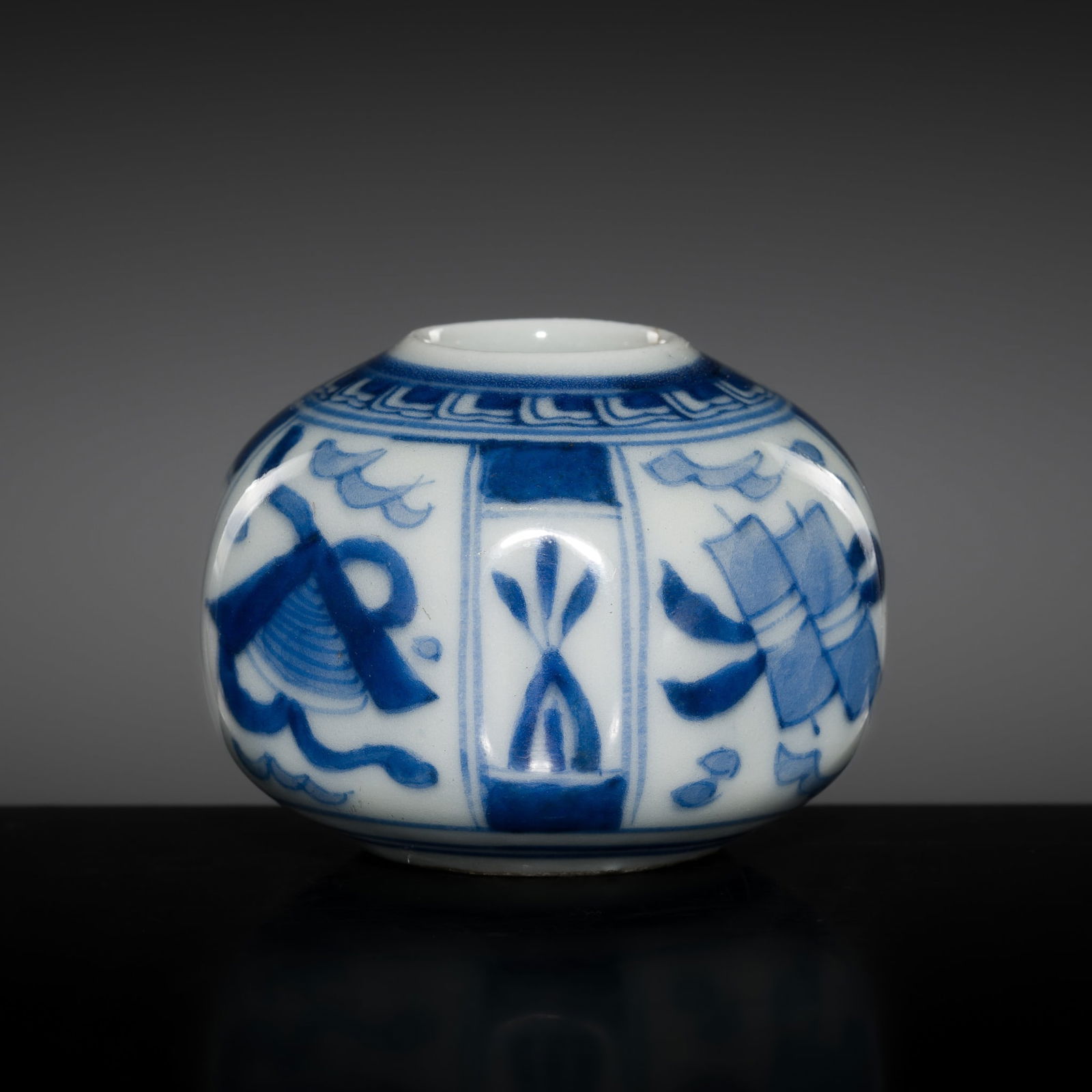A RARE BLUE AND WHITE PORCELAIN 'AUSPICIOUS ITEMS' OCTAGONAL JAR, QING DYNASTY, KANGXI PERIOD: A RARE BLUE AND WHITE PORCELAIN 'AUSPICIOUS ITEMS' OCTAGONAL JAR, QING DYNASTY, KANGXI PERIOD China, 1662-1722. Well-potted, the octagonal body with softly curved edges tapering gently toward the bas