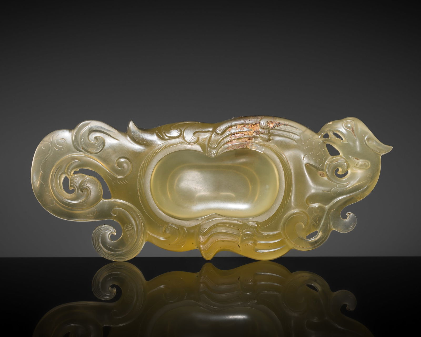A RARE OCHRE GLASS 'PHOENIX' BRUSH WASHER, POSSIBLY SIX-DYNASTIES PERIOD: A RARE OCHRE GLASS 'PHOENIX' BRUSH WASHER, POSSIBLY SIX-DYNASTIES PERIOD Expert's note: In the absence of closely comparable material from secure archaeological contexts or documented a