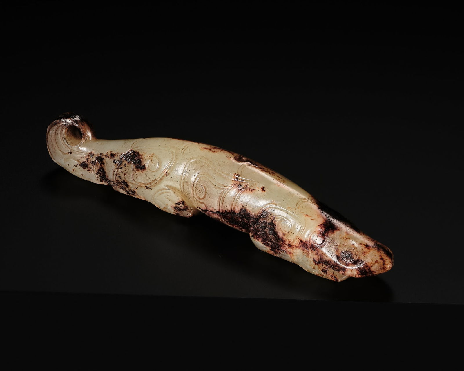 A PALE CELADON AND RUSSET JADE ZOOMORPHIC PENDANT, SHANG DYNASTY (1 of 13)