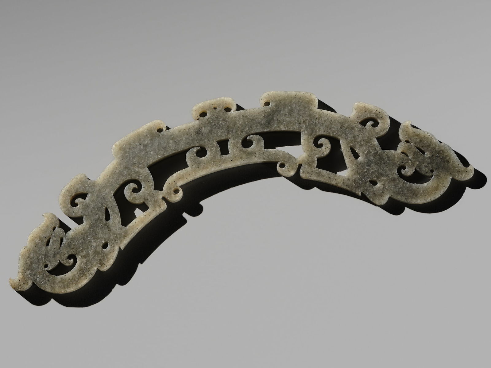 AN ARC-SHAPED 'TWIN DRAGON' JADE PENDANT, HUANG, EASTERN ZHOU PERIOD (1 of 11)