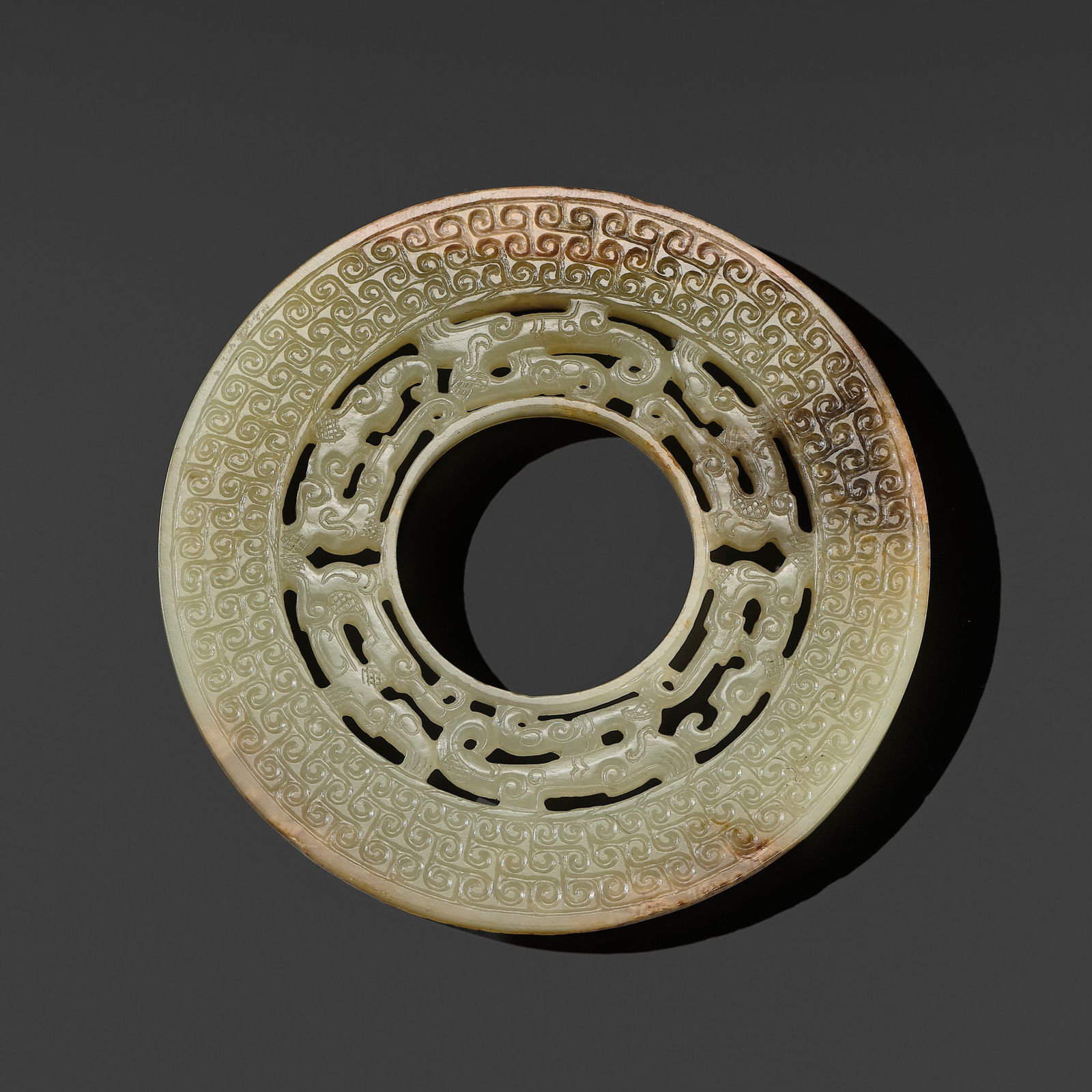 A GREEN JADE OPENWORK DISC, EASTERN ZHOU PERIOD (1 of 12)
