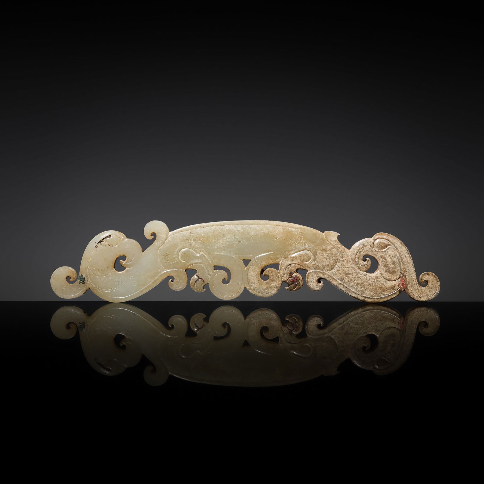 A VERY RARE WHITE JADE 'DOUBLE PHOENIX' PENDANT, LATE WARRING STATES PERIOD TO EARLY WESTERN HAN: A VERY RARE WHITE JADE 'DOUBLE PHOENIX' PENDANT, LATE WARRING STATES PERIOD TO EARLY WESTERN HAN DYNASTY China, c. 3rd-1st century BC. The flattened plaque, of a slightly curved form, symmetrically c