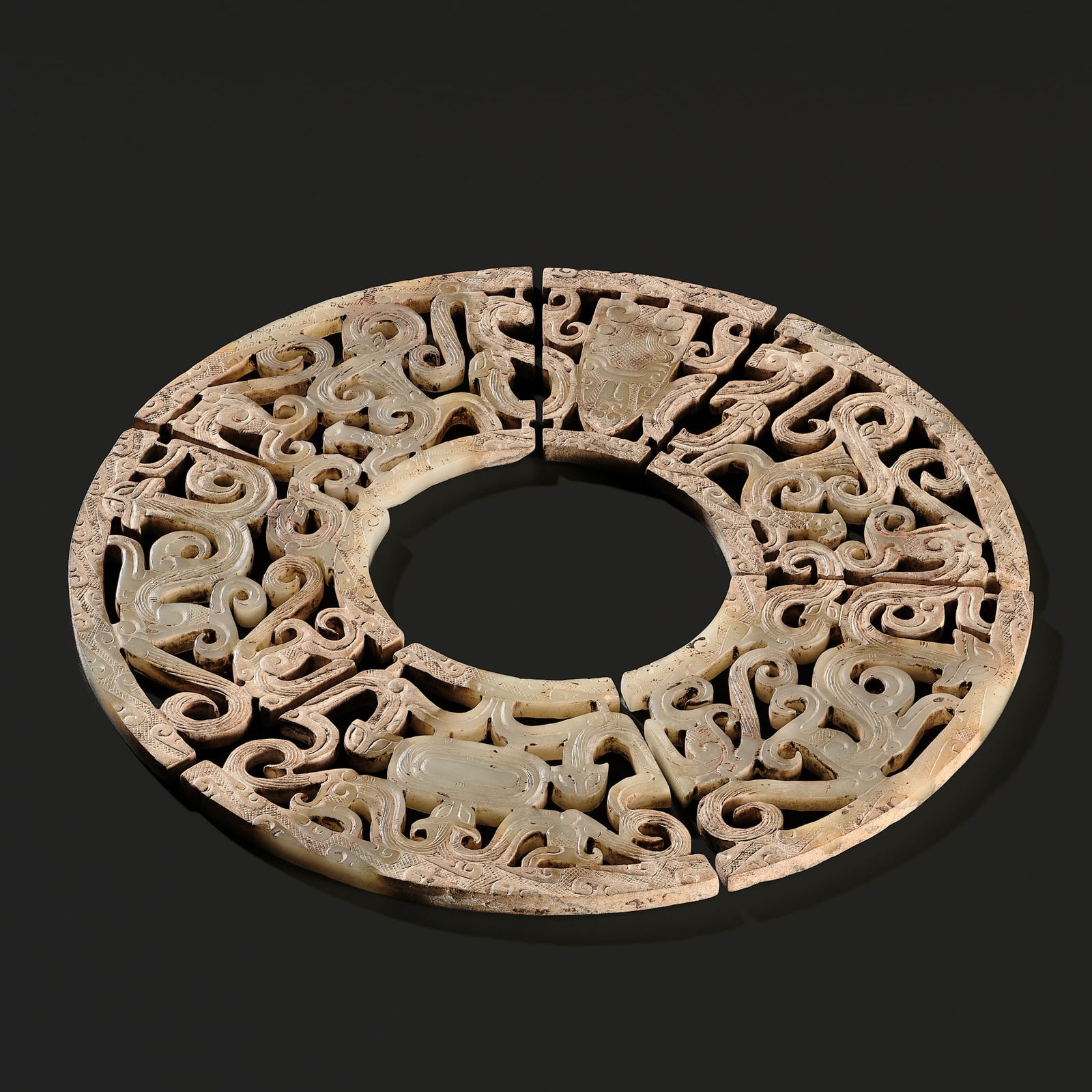A WHITE JADE SIX SEGMENTS 'CHILONG' OPENWORK DISK (BI), WARRING STATES PERIOD TO EARLY WESTERN HAN (1 of 16)