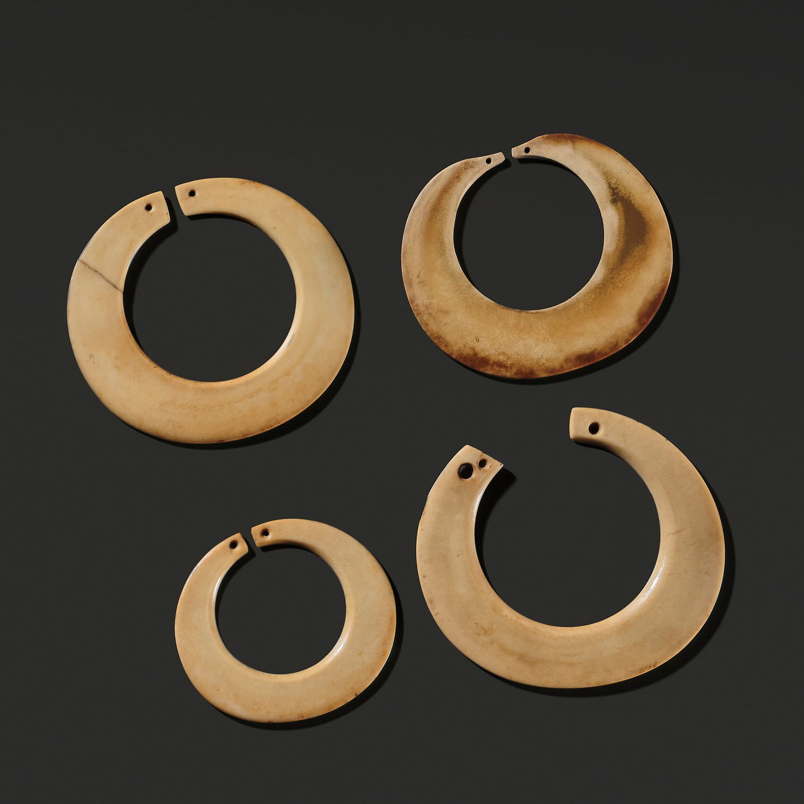 A RARE SET OF FOUR JADE EARRINGS, LATE EASTERN ZHOU-WESTERN HAN PERIOD (1 of 9)