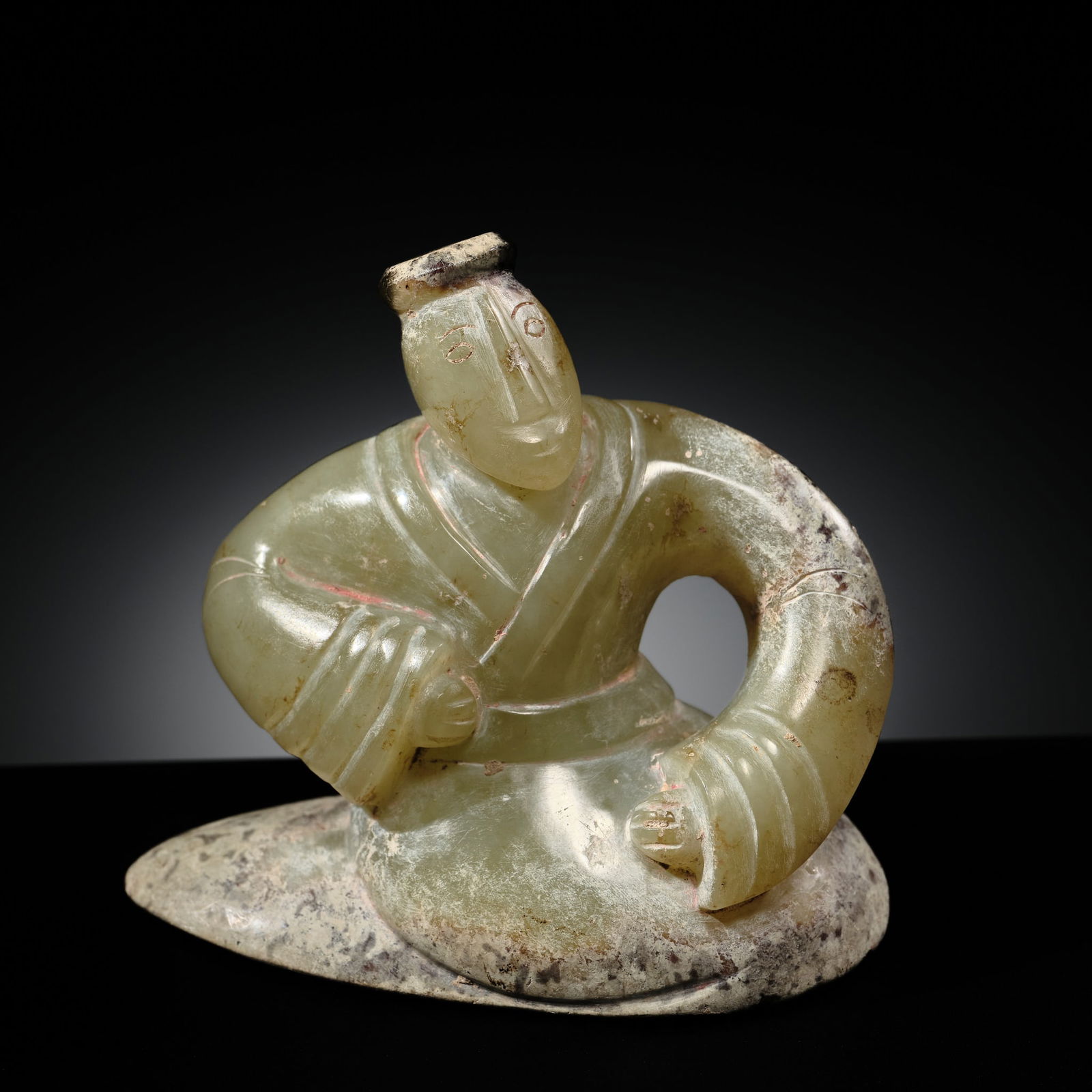 A FINE CELADON JADE KNEELING HUMAN FIGURE, HAN DYNASTY: A FINE CELADON JADE KNEELING HUMAN FIGURE, HAN DYNASTY Published: Jean-Paul Desroches (ed.) et al, The Beginning of the World. Dragons, Phoenix and Other Chimera, Fondation Baur, Geneva