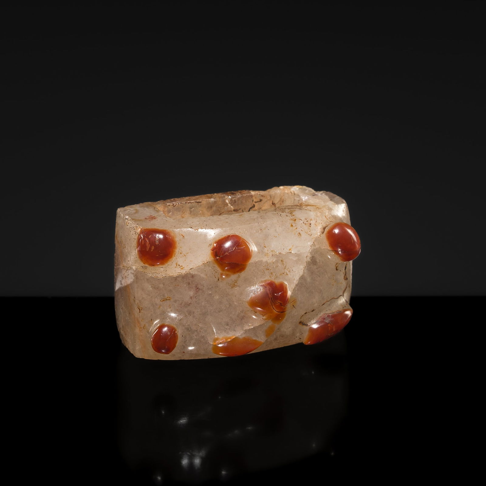 AN UNUSUAL WHITE AND RED AGATE SCABBARD SLIDE, WESTERN HAN DYNASTY: AN UNUSUAL WHITE AND RED AGATE SCABBARD SLIDE, WESTERN HAN DYNASTY China, 206 BC-9 AD. Rectangular in form with a slightly convex exterior, perforated to accommodate the scabbard, the outer surface d