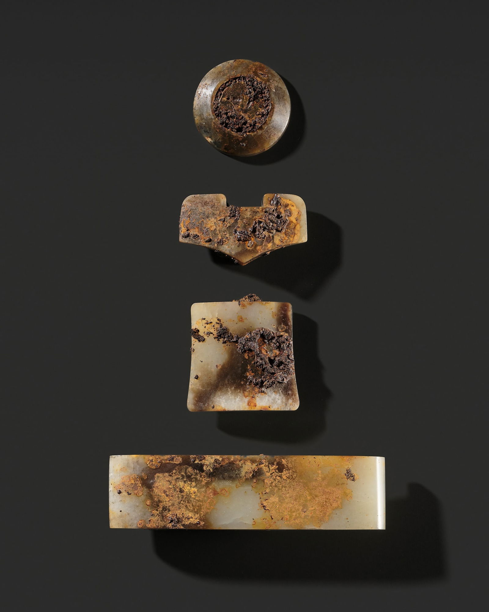 A FOUR-PIECE BEIGE AND BROWN JADE SWORD FITTING SET, WESTERN HAN DYNASTY (1 of 15)