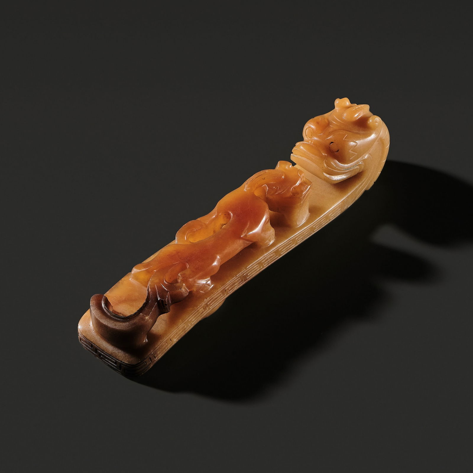 A LARGE CARAMEL AGATE 'DRAGON' BELT HOOK, QING DYNASTY (1 of 15)