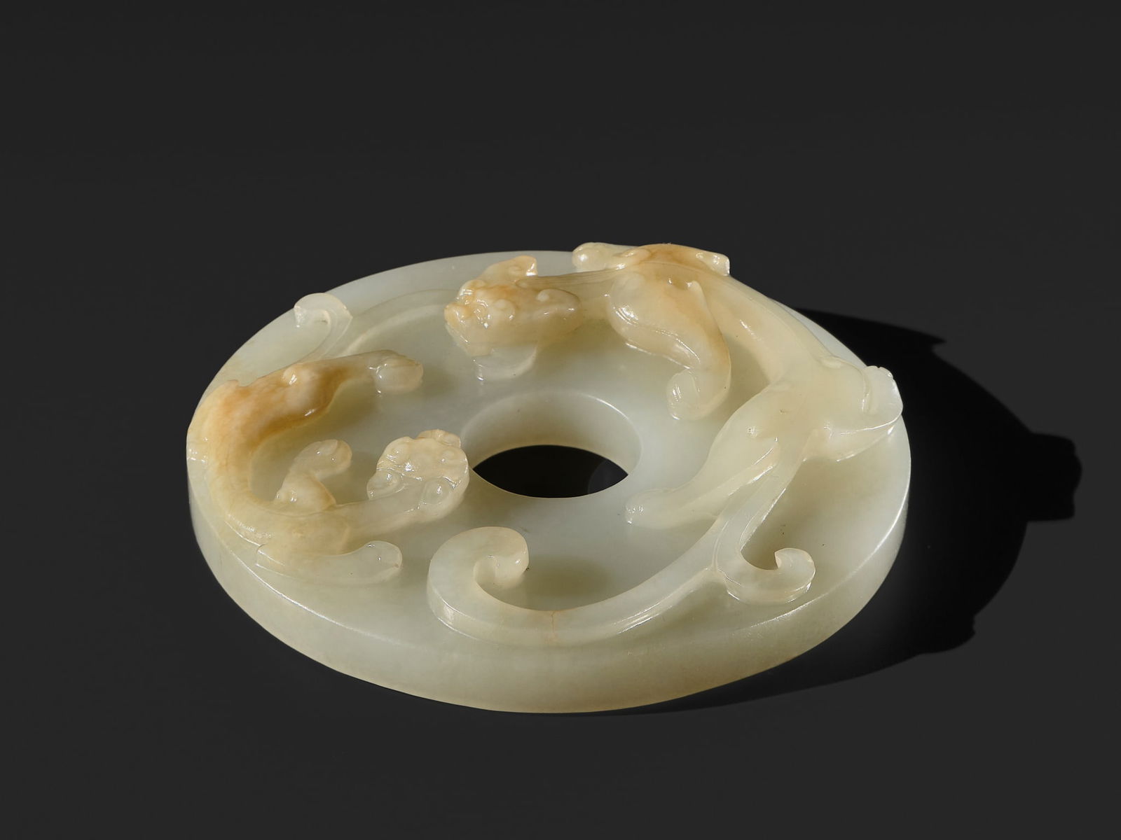 AN ARCHAISTIC WHITE JADE 'CHILONG' DISC (BI), QING DYNASTY (1 of 13)