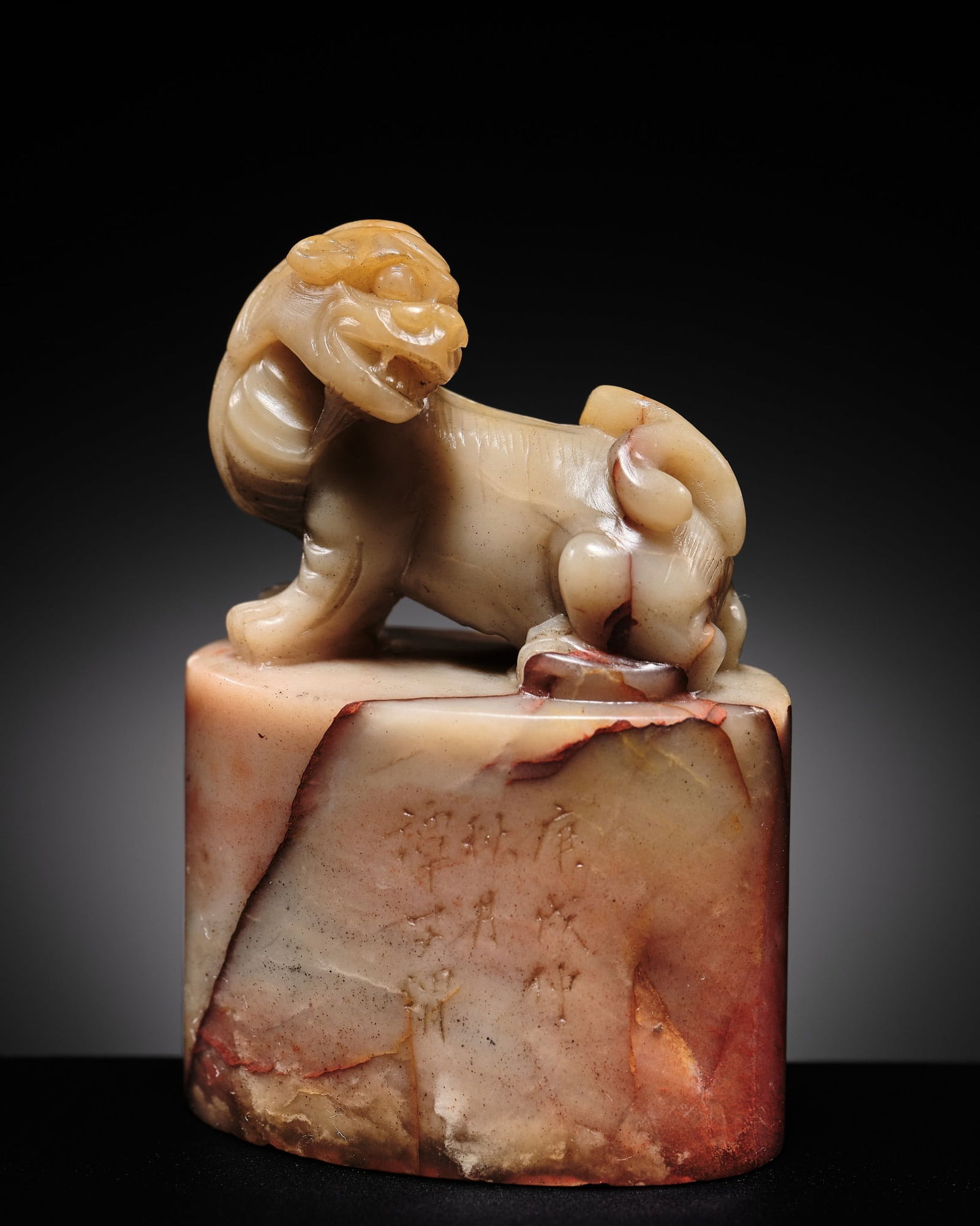 TAN ZIWEI: A FINE SHOUSHAN SOAPSTONE 'MYTHICAL BEAST' SEAL: TAN ZIWEI: A FINE SHOUSHAN SOAPSTONE 'MYTHICAL BEAST' SEAL China, 19th to early 20th century. Of oval cross-section, surmounted by a leonine beast reclining on its haunches, its head sharply turned t