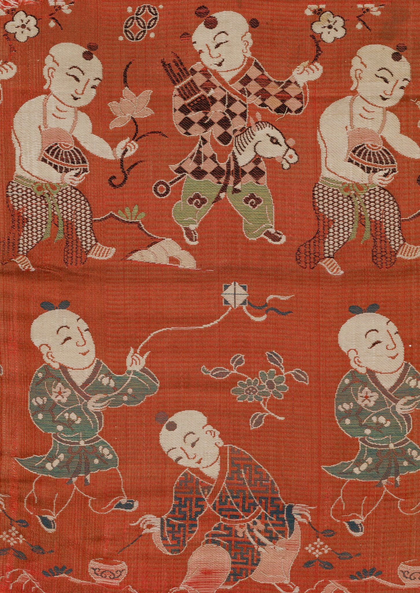 A 'BOYS AT PLAY' SILK PANEL, CIRCA 19TH CENTURY: A 'BOYS AT PLAY' SILK PANEL, CIRCA 19TH CENTURY Of rectangular form, finely embroidered in vivid colors to depict a group of six joyful children, all richly attired in flowing garments adorned with v