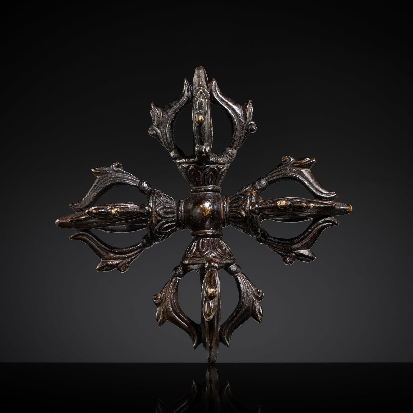 AN UNUSUAL BRONZE FIVE-PRONGED DOUBLE VAJRA: AN UNUSUAL BRONZE FIVE-PRONGED DOUBLE VAJRA Tibet, 18th-19th century or earlier. Boldly cast with a central globular grip, flanked by bands of stylized lotus petals in high relief,