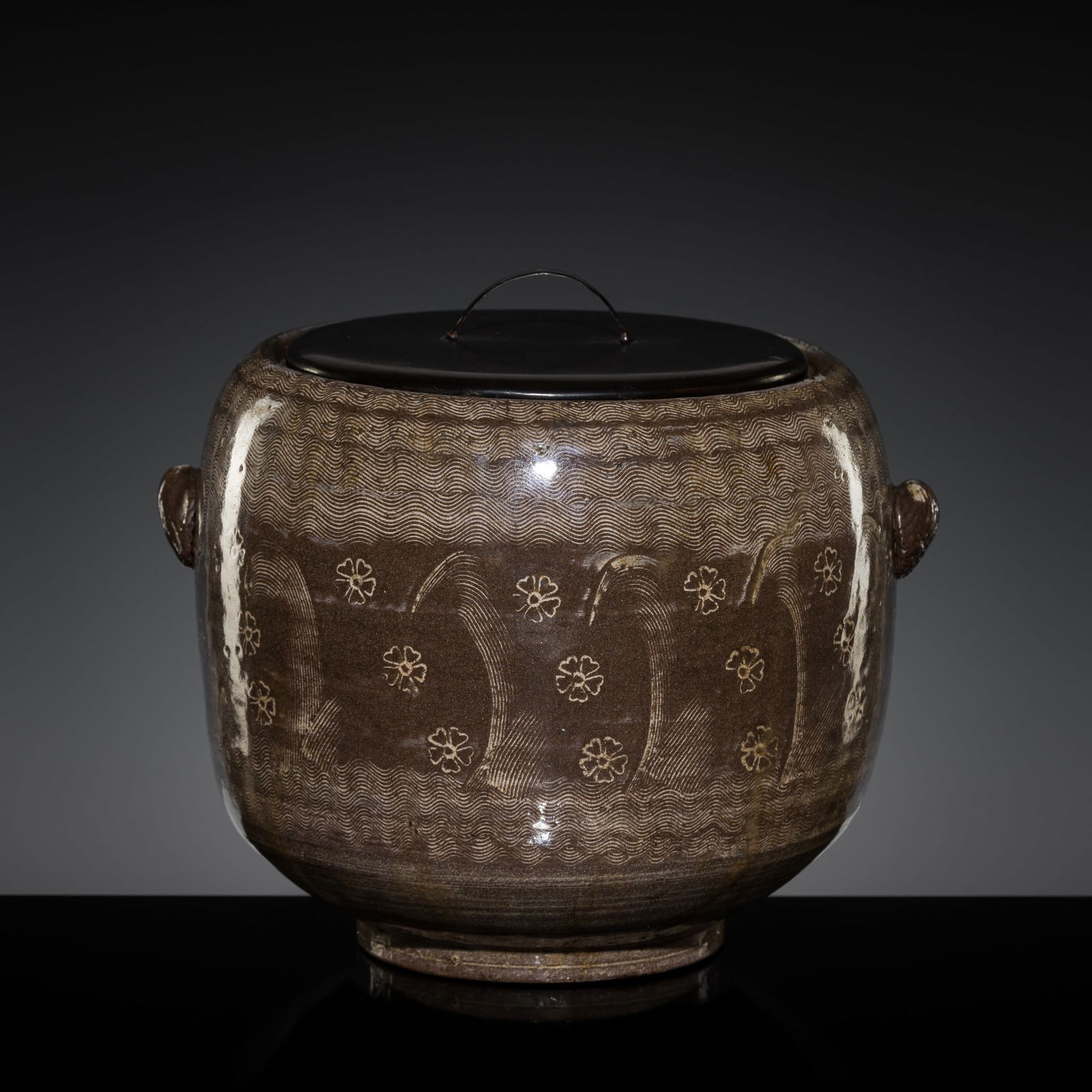 A BROWN-GLAZED KARATSU WARE 'PRUNUS' FRESH WATER JAR (MIZUSASHI) AND COVER, LATE MOMOYAMA PERIOD (1 of 11)