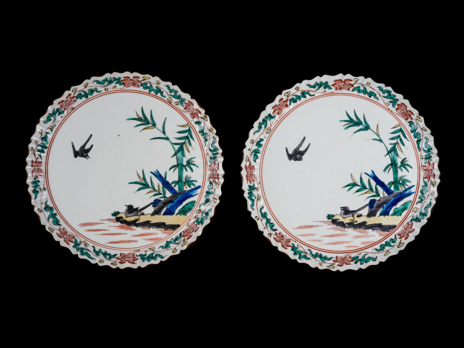 A PAIR OF KO-KUTANI 'BIRD AND BAMBOO' DISHES, EDO PERIOD: A PAIR OF KO-KUTANI 'BIRD AND BAMBOO' DISHES, EDO PERIOD Japan, late 17th century. Well-potted with rounded sides rising from a short ring foot to a wide, scalloped rim, decorated with yellow, black,