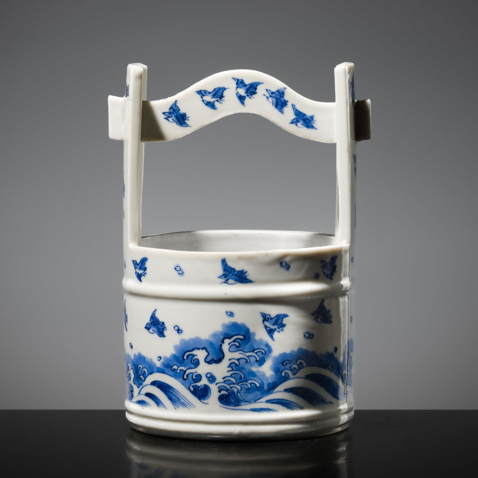 A BLUE AND WHITE PORCELAIN FRESH WATER JAR (MIZUSASHI): A BLUE AND WHITE PORCELAIN FRESH WATER JAR (MIZUSASHI) China for the Japanese market, circa 17th-18th century. Finely modeled in the form of a wooden bucket, the broad cylindrical