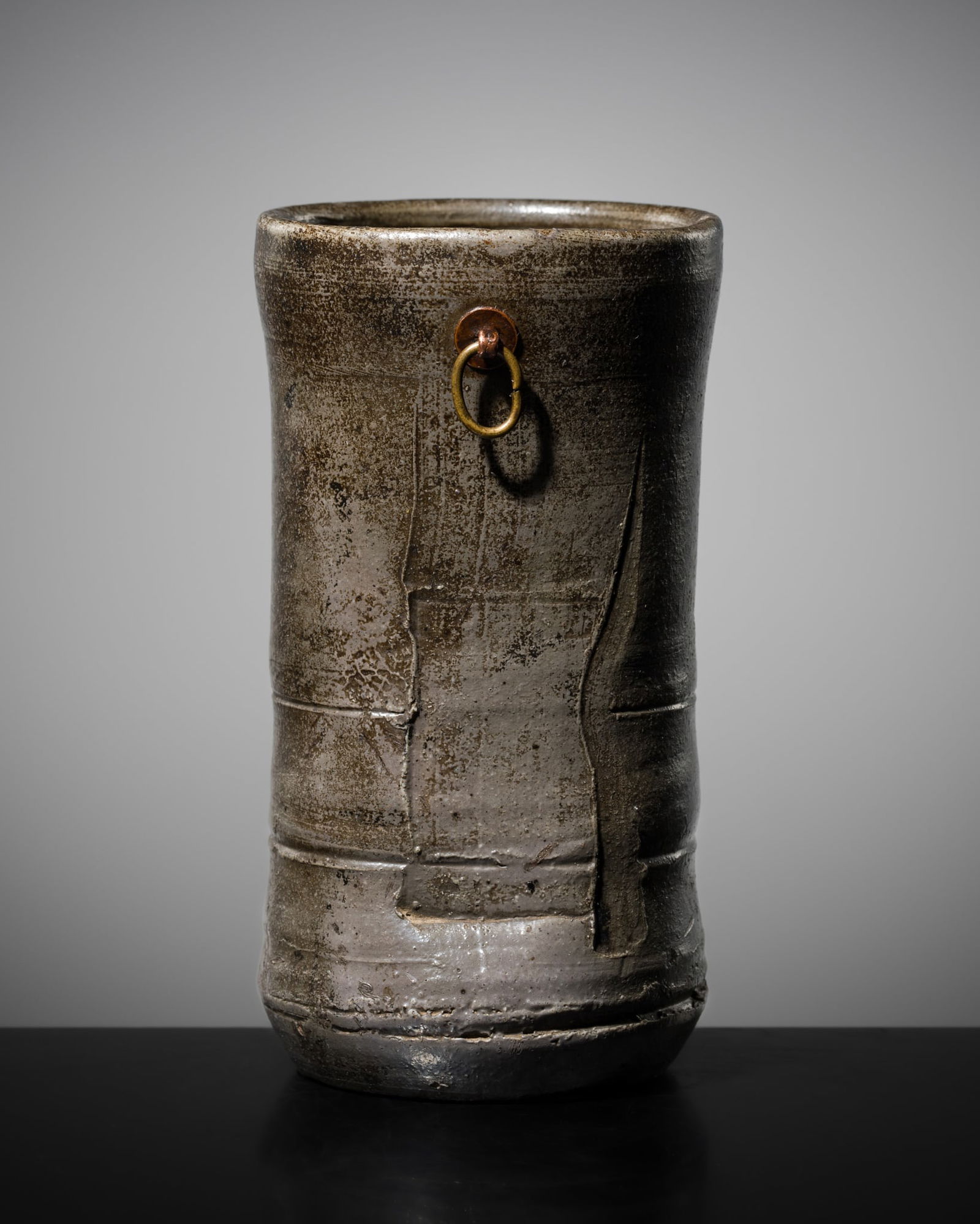 A BIZEN WARE 'BAMBOO' HANGING FLOWER VASE (HANAIRE), EDO PERIOD: A BIZEN WARE 'BAMBOO' HANGING FLOWER VASE (HANAIRE), EDO PERIOD Japan, 17th-18th century. The ceramic vessel is finely modeled, with an irregular circular section imitating the form of a bamboo stalk