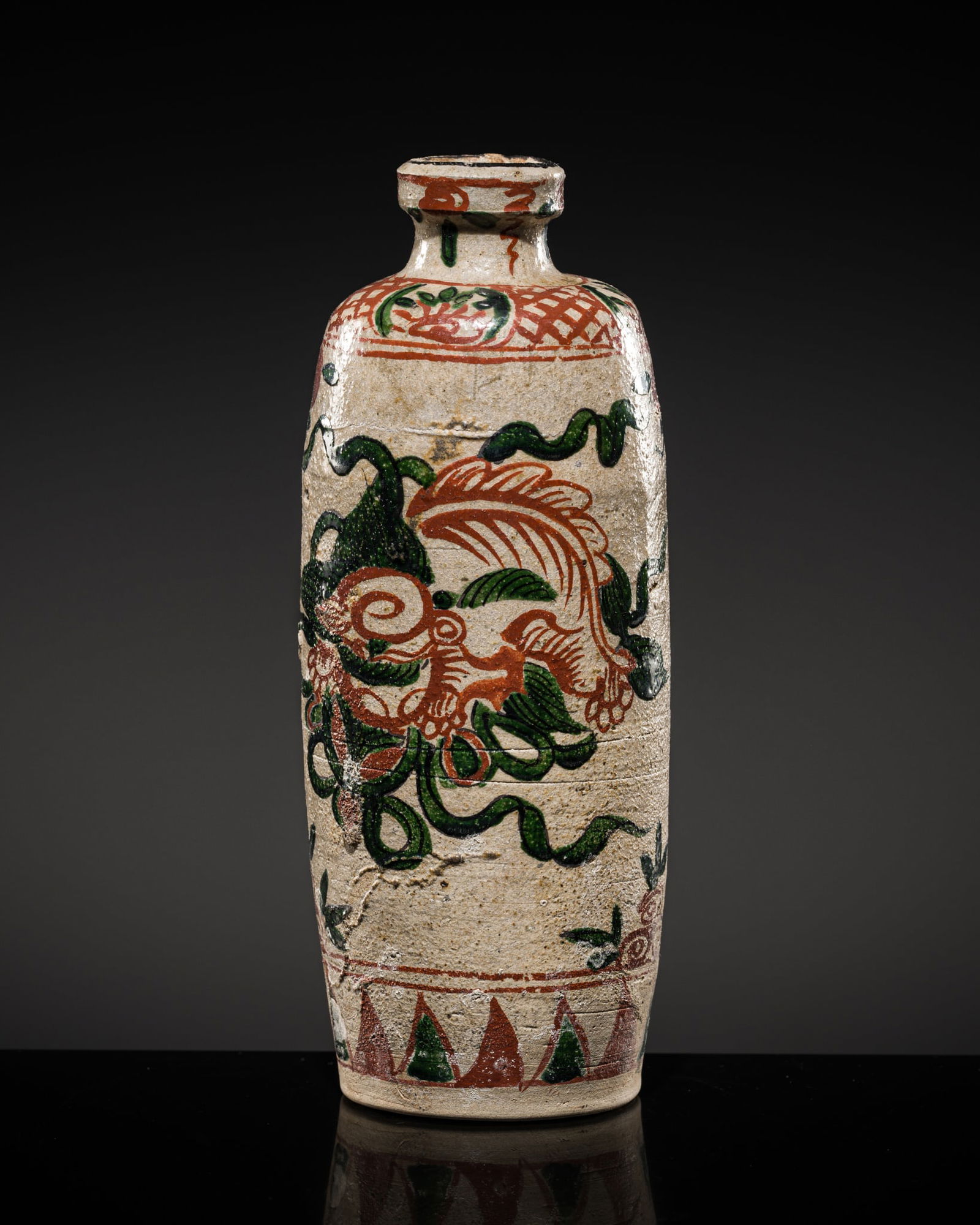 A SWATOW-STYLE TAMBA WARE 'FLORAL' SAKE BOTTLE, EDO PERIOD: A SWATOW-STYLE TAMBA WARE 'FLORAL' SAKE BOTTLE, EDO PERIOD Japan, Hyogo Prefecture, early 19th century. Boldly potted, of cylindrical form with gently concave sides, rising from a recessed base to a