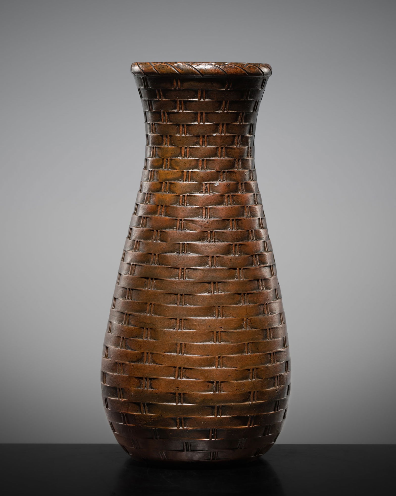 A BROWN-GLAZED STONEWARE 'WOVEN BAMBOO' VASE (HANAIRE), MEIJI TO TAISHO PERIOD: A BROWN-GLAZED STONEWARE 'WOVEN BAMBOO' VASE (HANAIRE), MEIJI TO TAISHO PERIOD China, early 20th century. Finely potted, the baluster-shaped body rising from a flat base to a waisted neck with a thic