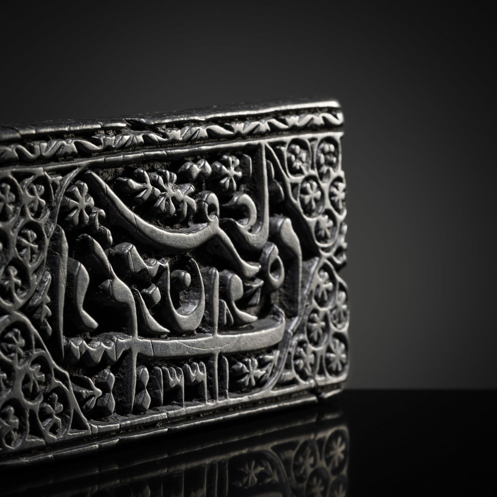 A CARVED HARDWOOD SEAL WITH A POEM BY SAADI SHIRAZI, PERSIA, DATED 1912: A CARVED HARDWOOD SEAL WITH A POEM BY SAADI SHIRAZI, PERSIA, DATED 1912 Of rectangular form, carved from a dense, dark hardwood with a handle at the reverse. The seal face is deeply carved in high re