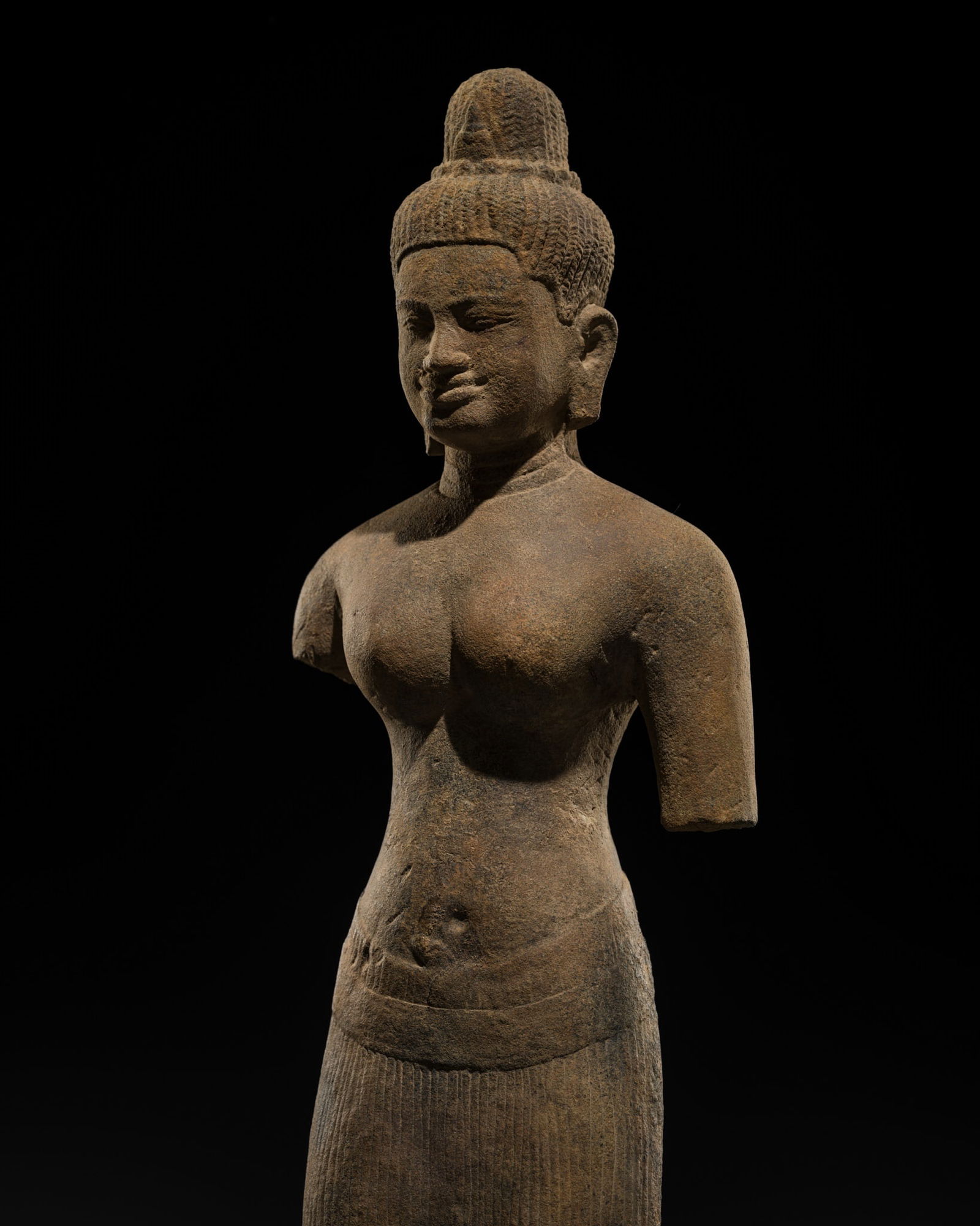 A SANDSTONE FIGURE OF A FEMALE DEITY, BAPHUON STYLE, ANGKOR PERIOD (1 of 13)