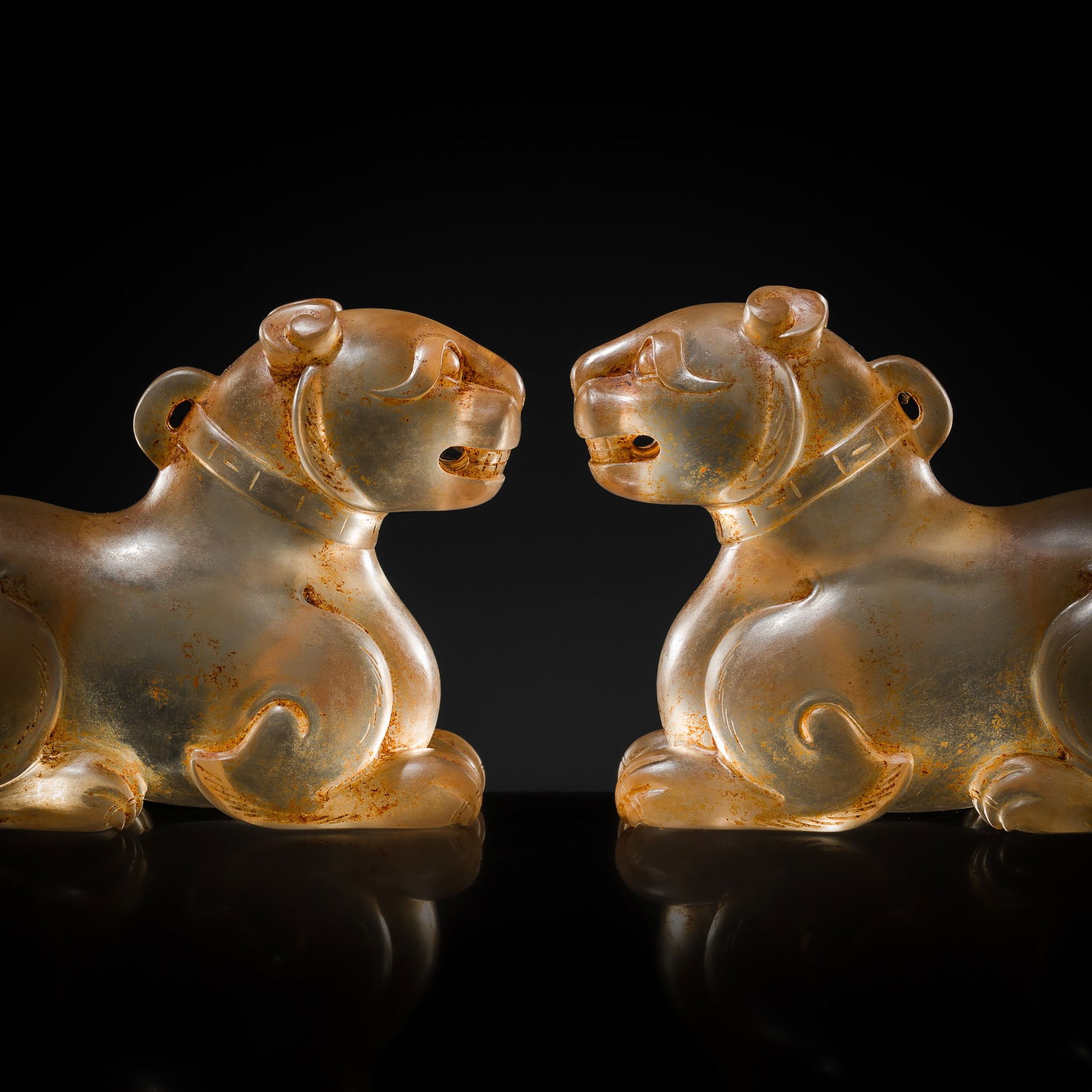 AN EXCEPTIONALLY WELL CARVED PAIR OF ROCK CRYSTAL FELINE FIGURES, HAN DYNASTY: AN EXCEPTIONALLY WELL CARVED PAIR OF ROCK CRYSTAL FELINE FIGURES, HAN DYNASTY This lot is from a single owner collection and is therefore offered without reserve China, 206 BC-220 AD. The recumbent be