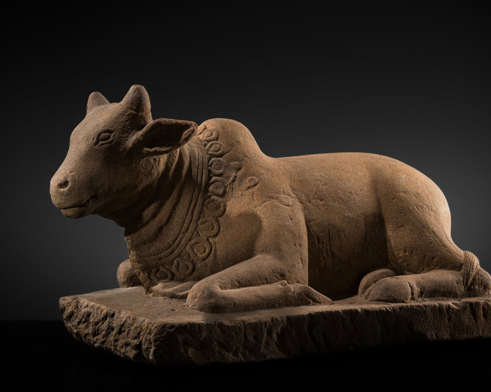 A MAGNIFICENT SANDSTONE STATUE OF NANDI, PRE-ANGKOR PERIOD, 8TH-9TH CENTURY (1 of 20)