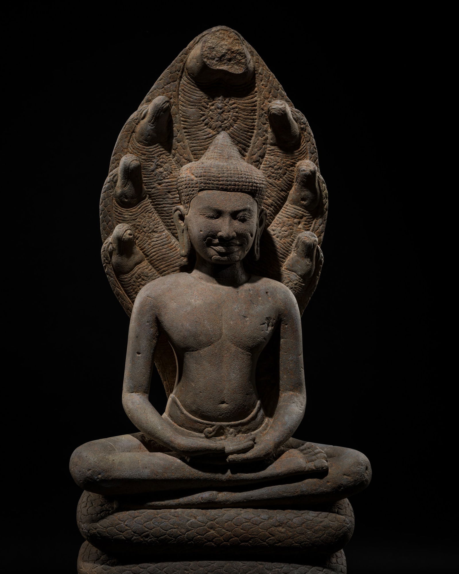 AN EXCEPTIONALLY WELL-PRESERVED SANDSTONE FIGURE OF BUDDHA MUCHALINDA, BAYON STYLE, LATE 12TH-EARLY (1 of 16)