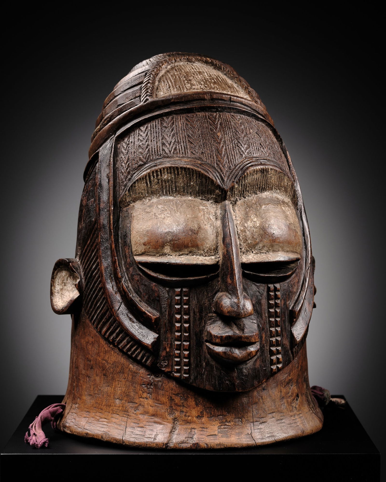 A CARVED AND PAINTED WOOD HELM MASK, OJUEGU OR ODUMADO, IGALA CULTURE, NIGERIA, CIRCA 1900 (1 of 20)
