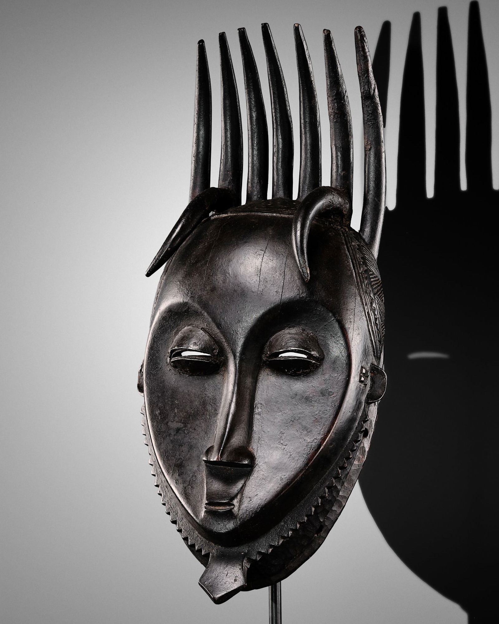 A CARVED WOOD NDOMA MASK, GURO CULTURE, CÔTE D'IVOIRE, LATE 19TH TO EARLY 20TH CENTURY (1 of 20)