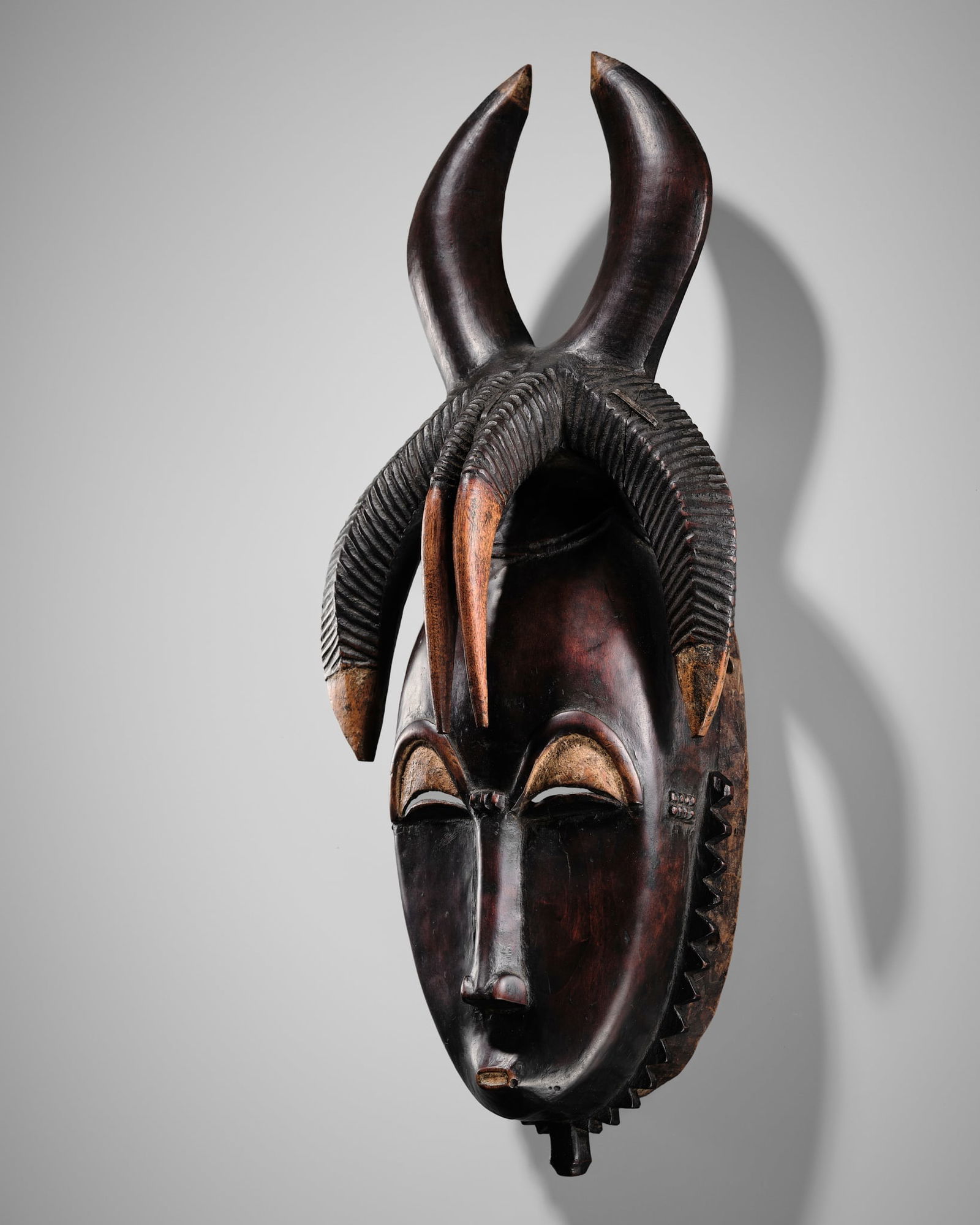 A CARVED WOOD MASK, GYÈ, YAURE CULTURE, CÔTE D'IVOIRE, LATE 19TH TO EARLY 20TH CENTURY (1 of 20)