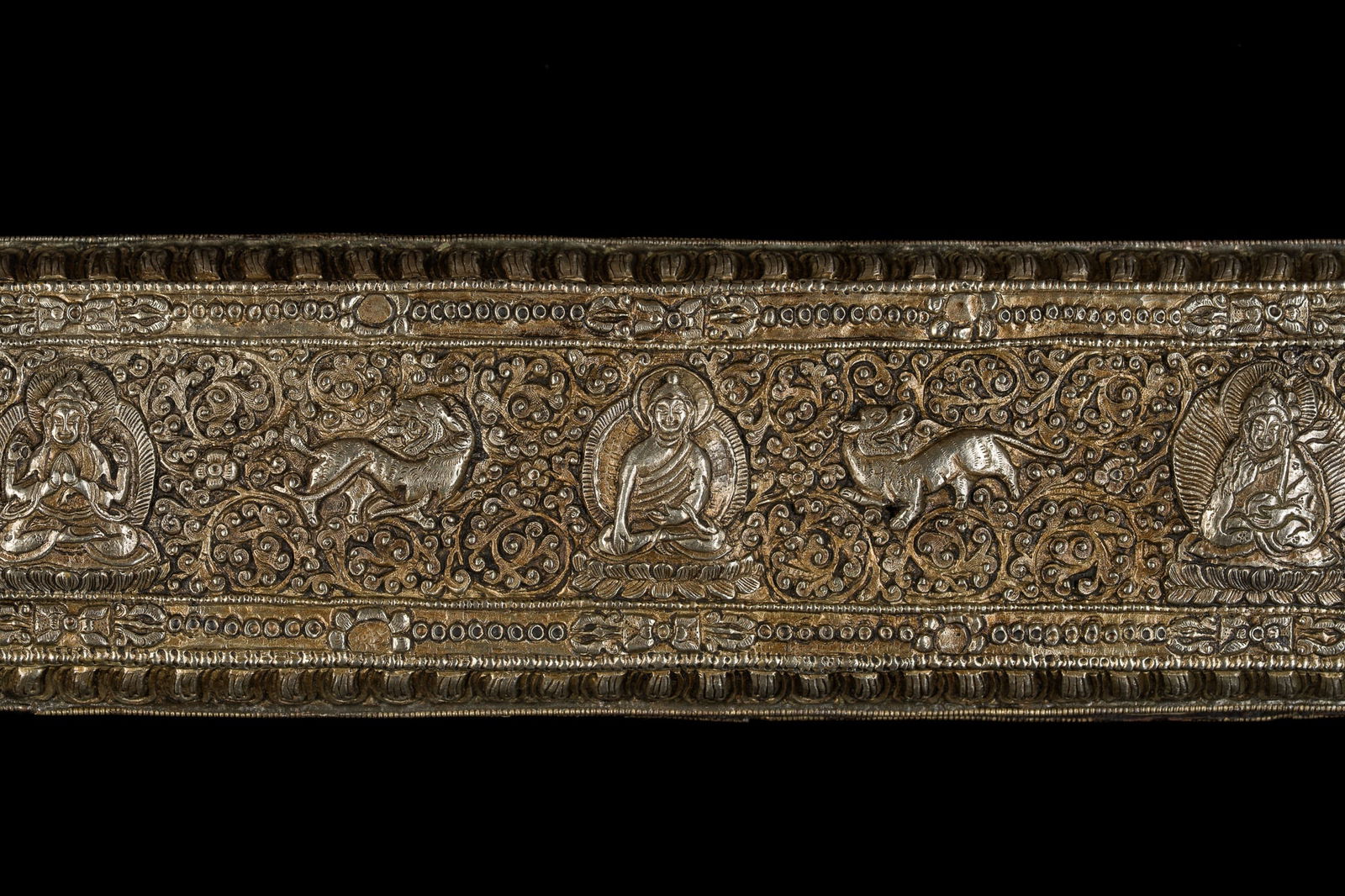 A RARE AND IMPORTANT WOOD AND SILVER REPOUSSÉ SUTRA COVER AND MANUSCRIPT, 18TH-19TH CENTURY: A RARE AND IMPORTANT WOOD AND SILVER REPOUSSÉ SUTRA COVER AND MANUSCRIPT, 18TH-19TH CENTURY This lot is from a single owner collection and is therefore offered without reserve Tibet. Comprising a mat