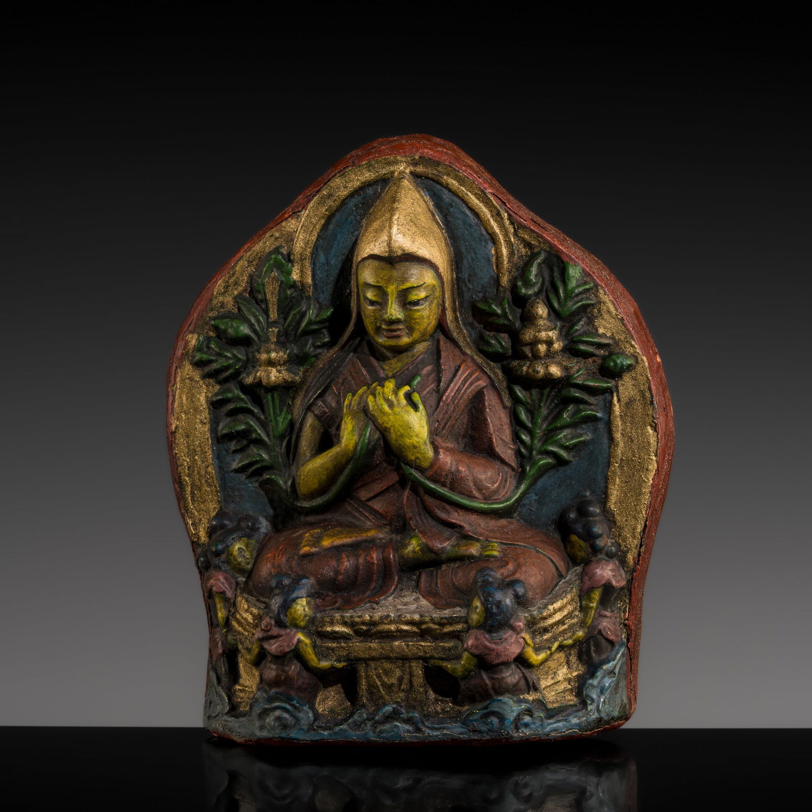A POLYCHROME FIRED CLAY TSA-TSA DEPICTING TSONGKAPA, 18TH-19TH CENTURY: A POLYCHROME FIRED CLAY TSA-TSA DEPICTING TSONGKAPA, 18TH-19TH CENTURY This lot is from a single owner collection and is therefore offered without reserve Tibet. Brightly painted in polychrome pigment