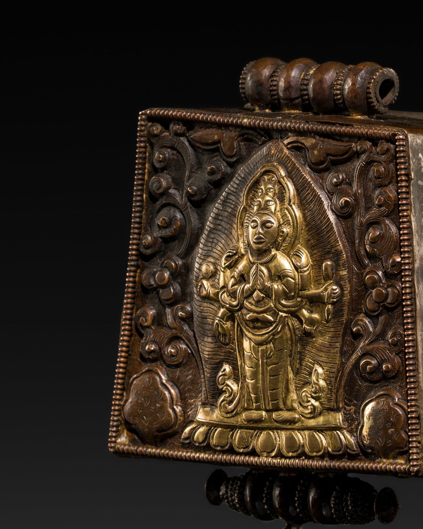 A PARCEL-GILT COPPER REPOUSSÉ AMULET BOX DEPICTING EKADASHAMUKHA AVALOKITESHVARA, GAU, 19TH CENTURY (1 of 11)