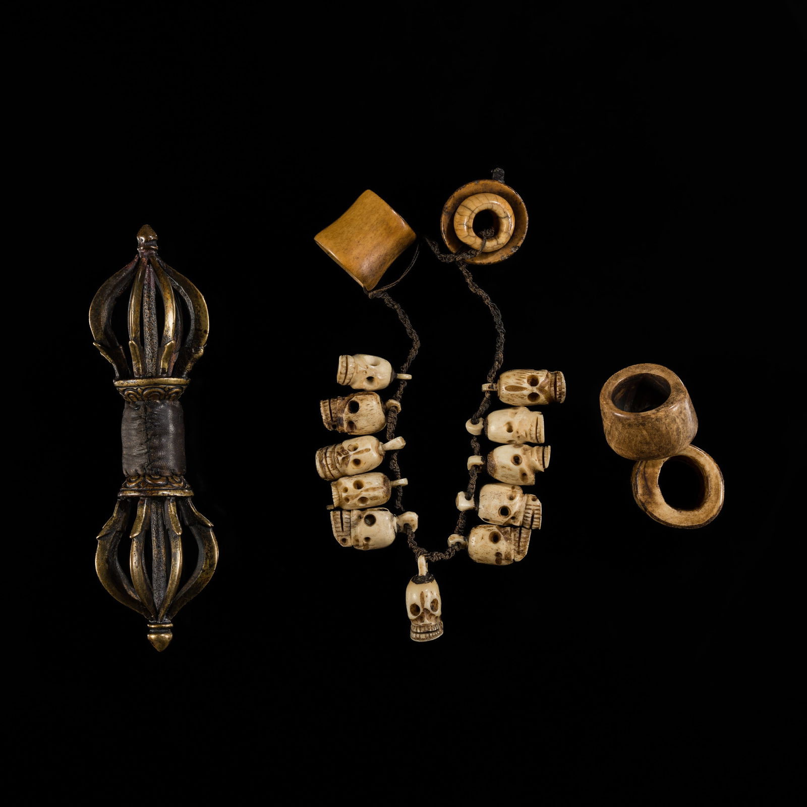 A SET OF AN EIGHT-PRONGED GILT-BRONZE VAJRA, A BONE SKULL MALA AND TWO BONE BEADS, 17TH-18TH CENTURY (1 of 20)