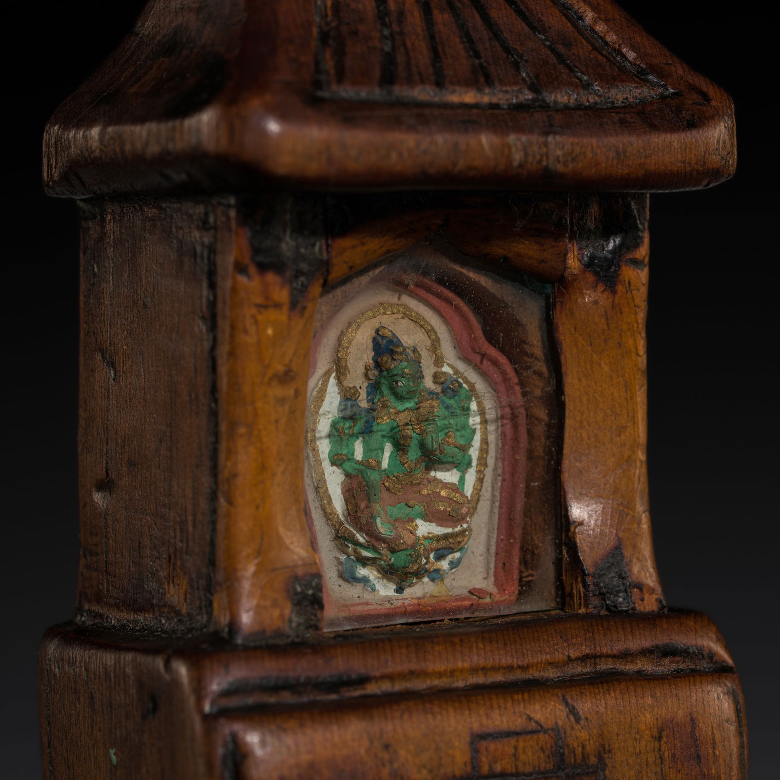 A PORTABLE WOOD SHRINE WITH A PAINTED CLAY TSA-TSA OF GREEN TARA, GAU, 18TH-19TH CENTURY (1 of 10)