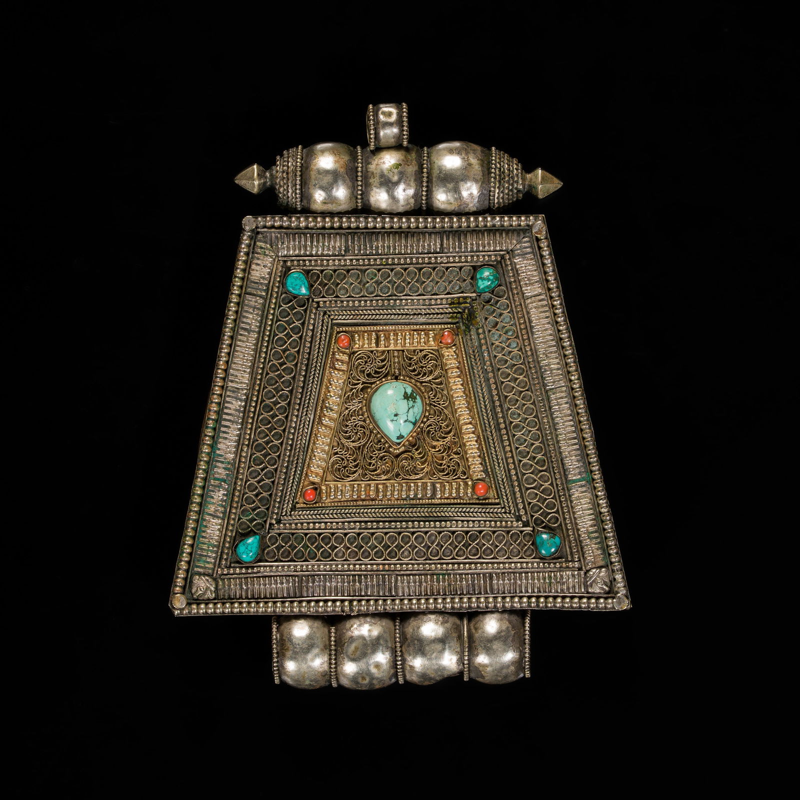 A TURQUOISE AND CORAL INLAID PARCEL-GILT METAL AMULET BOX, GAU, 19TH CENTURY: A TURQUOISE AND CORAL INLAID PARCEL-GILT METAL AMULET BOX, GAU, 19TH CENTURY This lot is from a single owner collection and is therefore offered without reserve Tibet. Of trapezoidal form, finely work
