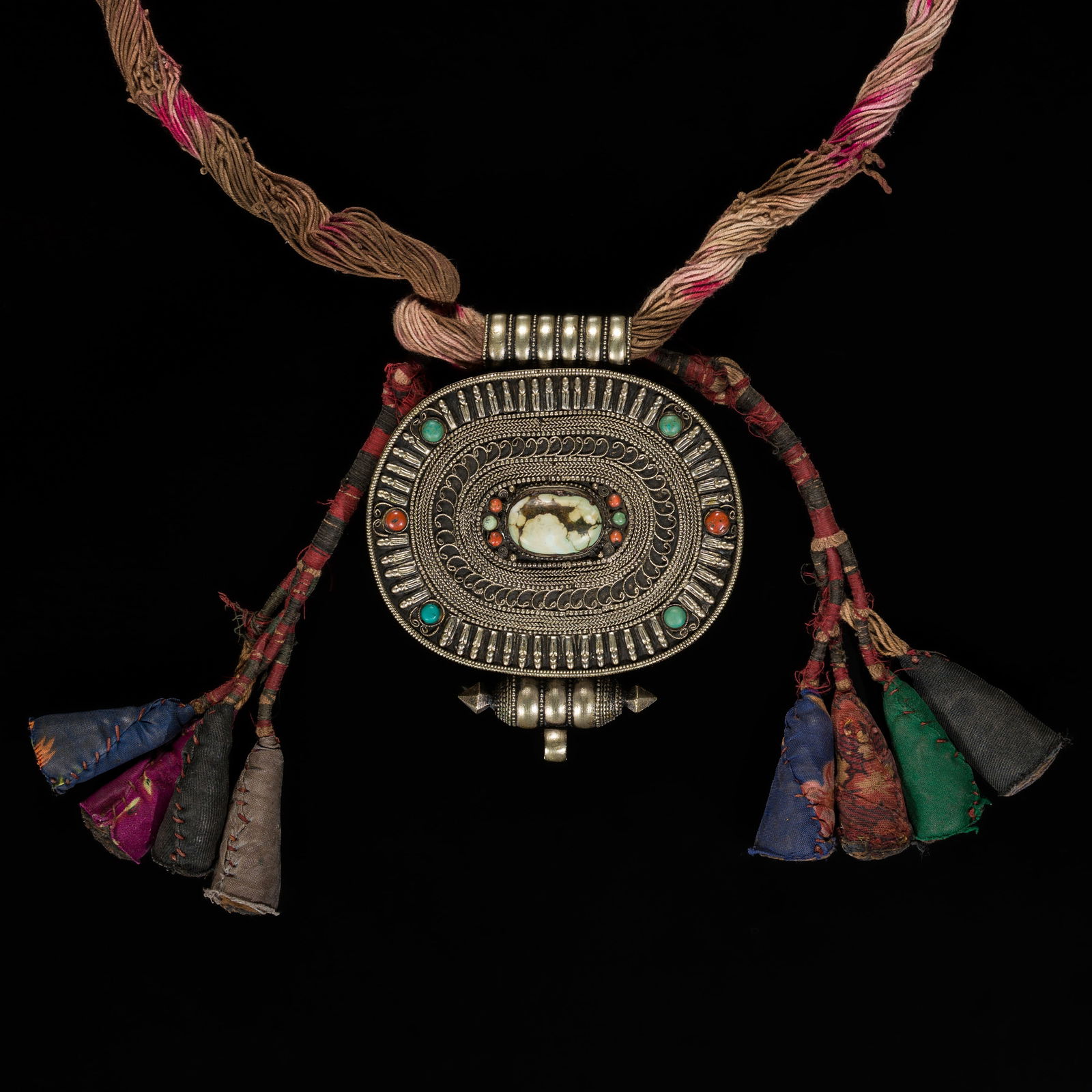 A TURQUOISE AND CORAL NECKLACE WITH A SILVER AND COPPER AMULET BOX, GAU, 19TH CENTURY: A TURQUOISE AND CORAL NECKLACE WITH A SILVER AND COPPER AMULET BOX, GAU, 19TH CENTURY This lot is from a single owner collection and is therefore offered without reserve Tibet. The box is of oval form