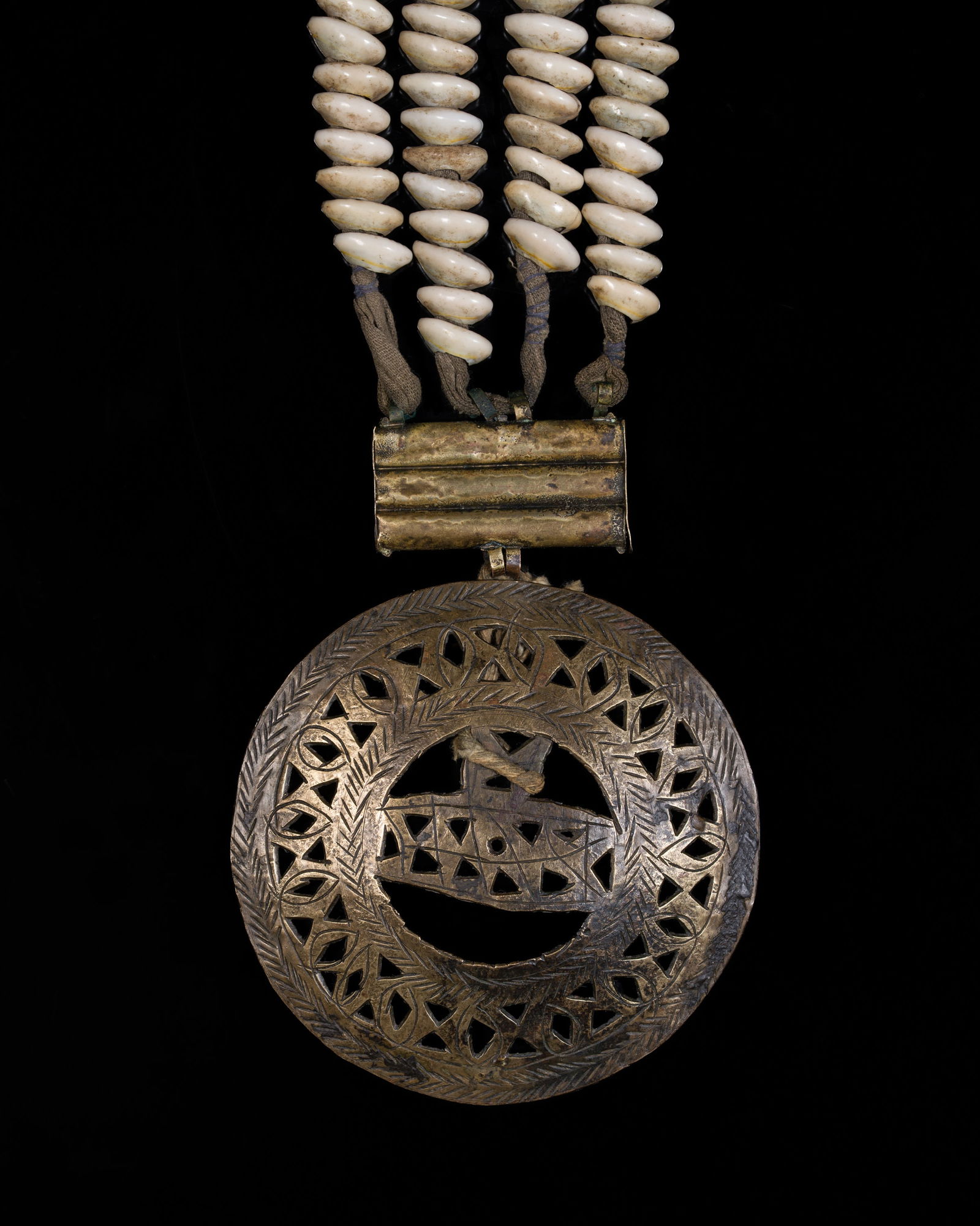 A COWRIE SHELL AND BRASS 'MANDALA' DODCHA (BELT ORNAMENT), EARLY 20TH CENTURY: A COWRIE SHELL AND BRASS 'MANDALA' DODCHA (BELT ORNAMENT), EARLY 20TH CENTURY This lot is from a single owner collection and is therefore offered without reserve North India, Ladakh. Consisting of fou