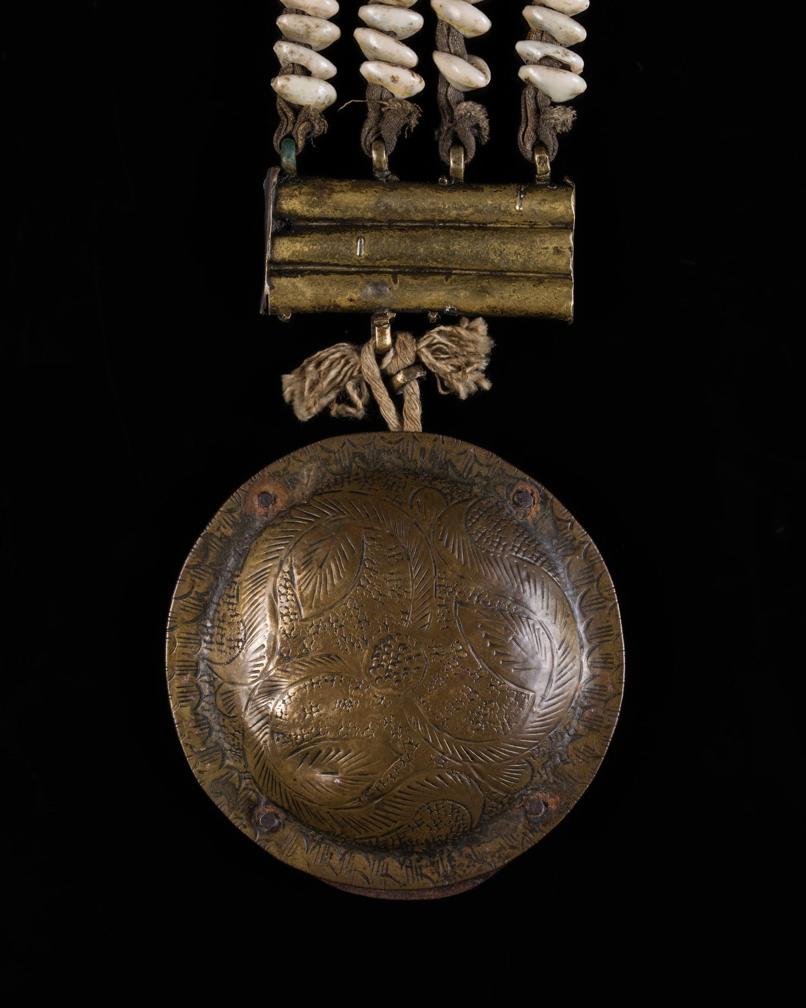 A LARGE COWRIE SHELL AND BRASS DODCHA (BELT ORNAMENT), EARLY 20TH CENTURY: A LARGE COWRIE SHELL AND BRASS DODCHA (BELT ORNAMENT), EARLY 20TH CENTURY This lot is from a single owner collection and is therefore offered without reserve North India, Ladakh. Consisting of four st