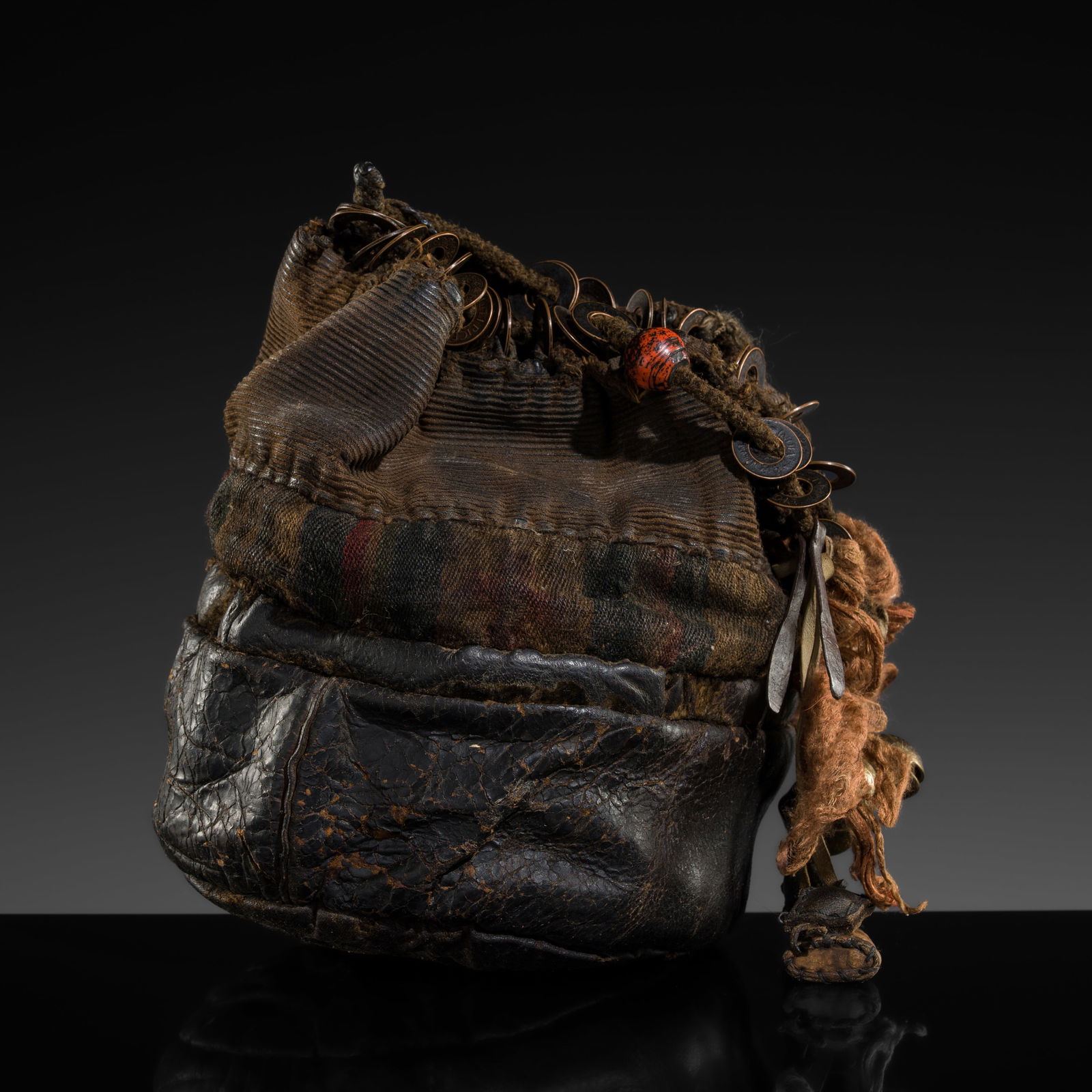 A SHAMANIC LEATHER PURSE, NORTHEASTERN INDIA, 20TH CENTURY AND EARLIER (1 of 11)