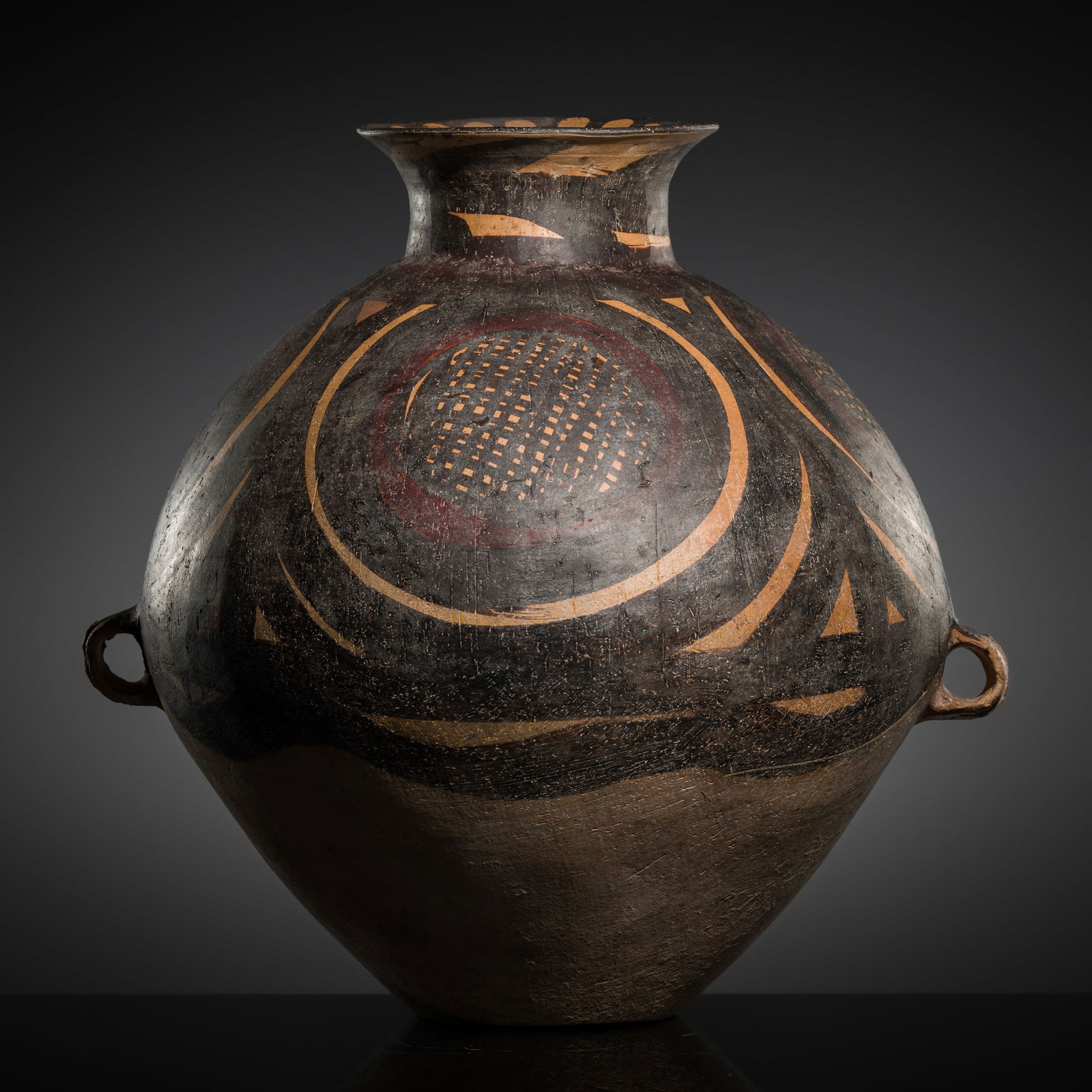 A LARGE PAINTED TWO-HANDLED POTTERY JAR, NEOLITHIC PERIOD: A LARGE PAINTED TWO-HANDLED POTTERY JAR, NEOLITHIC PERIOD This lot is from a single owner collection and is therefore offered without reserve China, Majiayao culture, 3rd-2nd millennium BC. The com