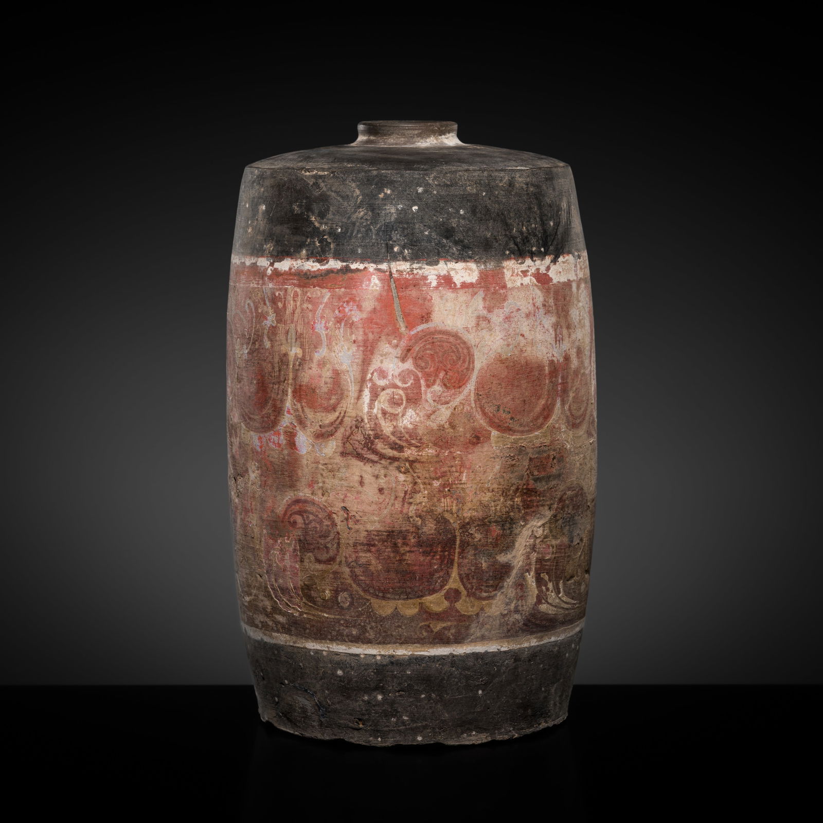 A PAINTED POTTERY CYLINDRICAL JAR, HAN DYNASTY: A PAINTED POTTERY CYLINDRICAL JAR, HAN DYNASTY This lot is from a single owner collection and is therefore offered without reserve China, 202 BC - 220 AD. The cylindrical body rises from a flat foot t