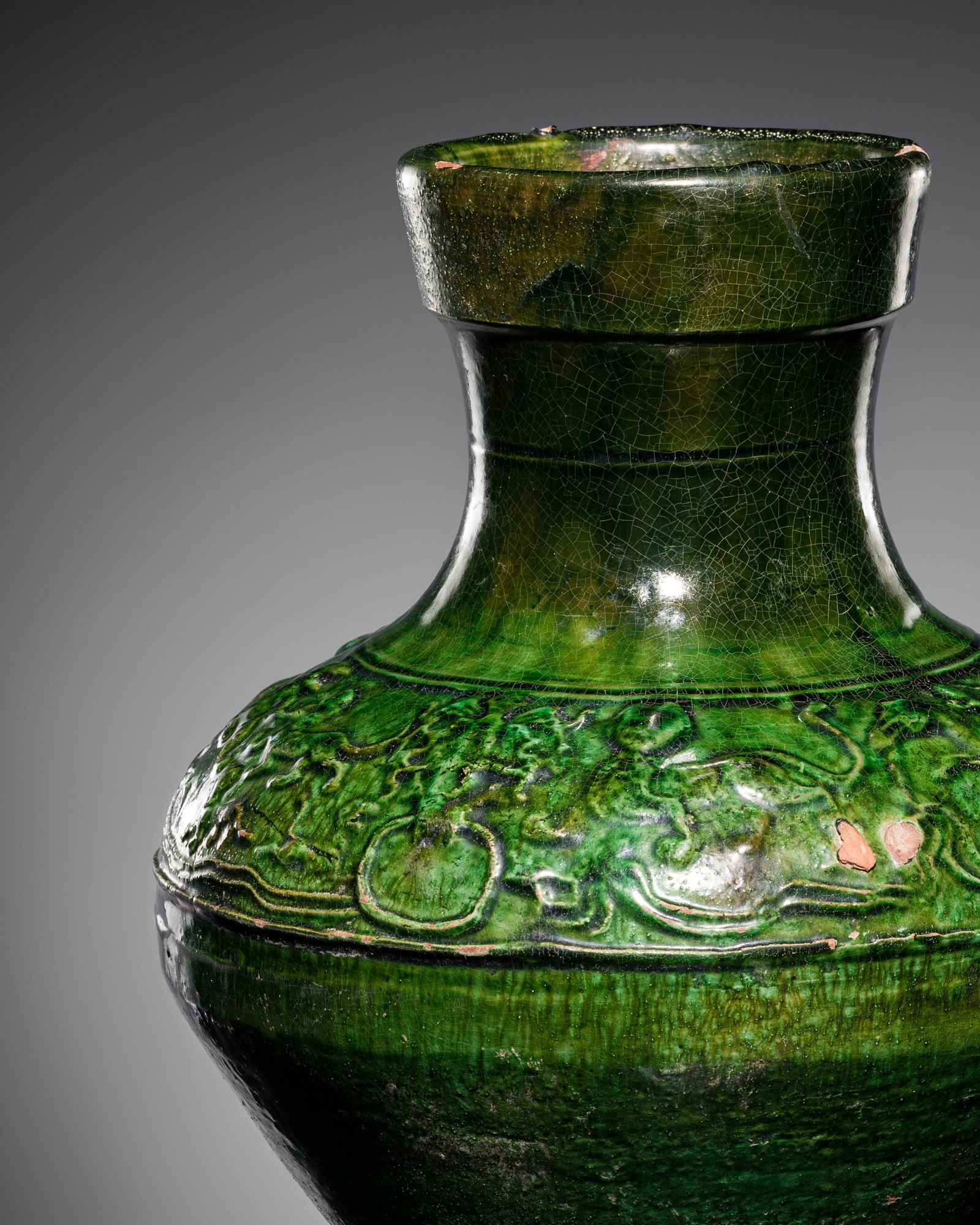 A GREEN-GLAZED POTTERY JAR, HU, HAN DYNASTY: A GREEN-GLAZED POTTERY JAR, HU, HAN DYNASTY This lot is from a single owner collection and is therefore offered without reserve China, 206 BC-220 AD. The robust pear-shaped body rises from a flat foot
