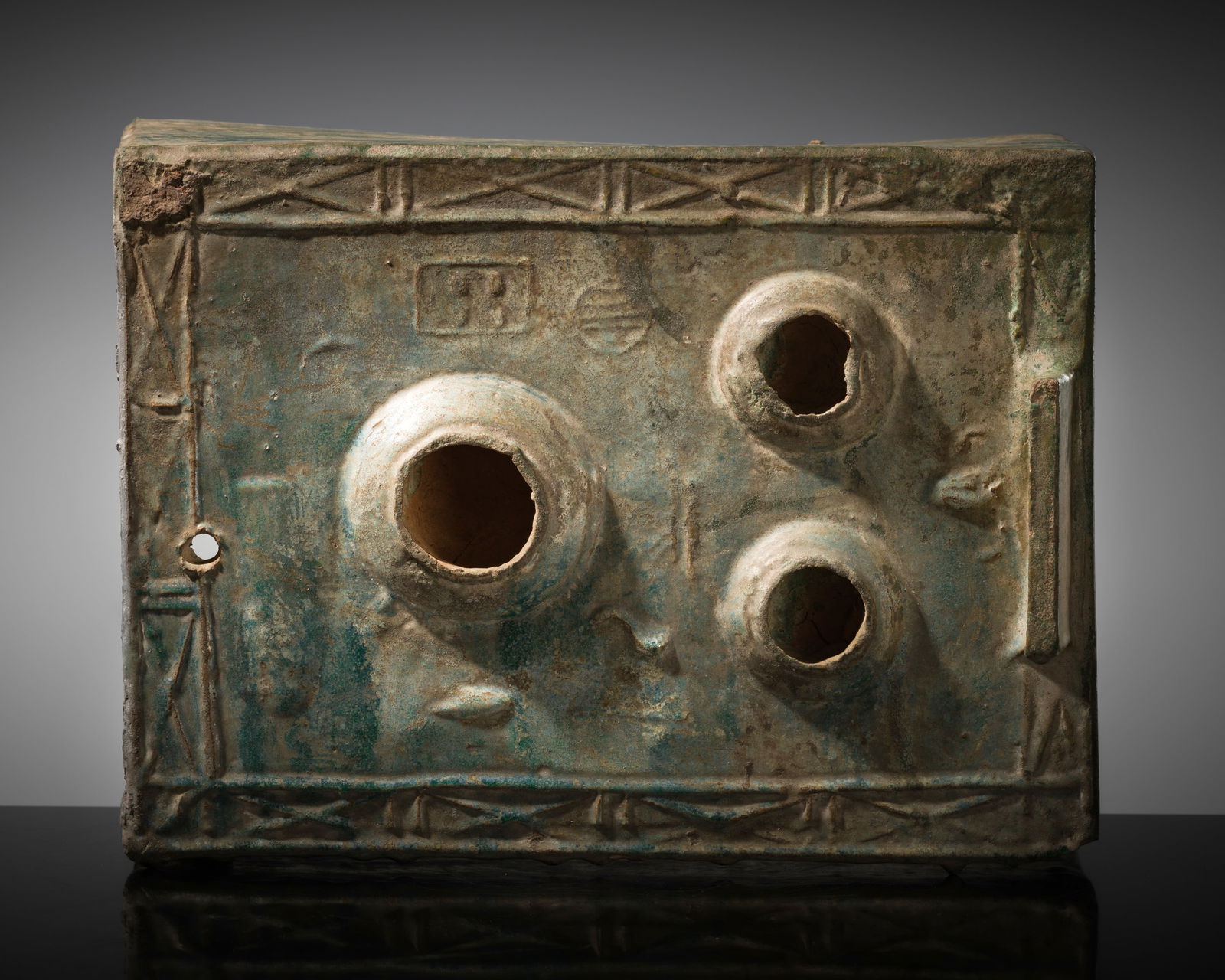 A GREEN-GLAZED POTTERY MODEL OF A COOKING STOVE, HAN DYNASTY: A GREEN-GLAZED POTTERY MODEL OF A COOKING STOVE, HAN DYNASTY This lot is from a single owner collection and is therefore offered without reserve China, 202 BC - 220 AD. The well-potted model of rectan