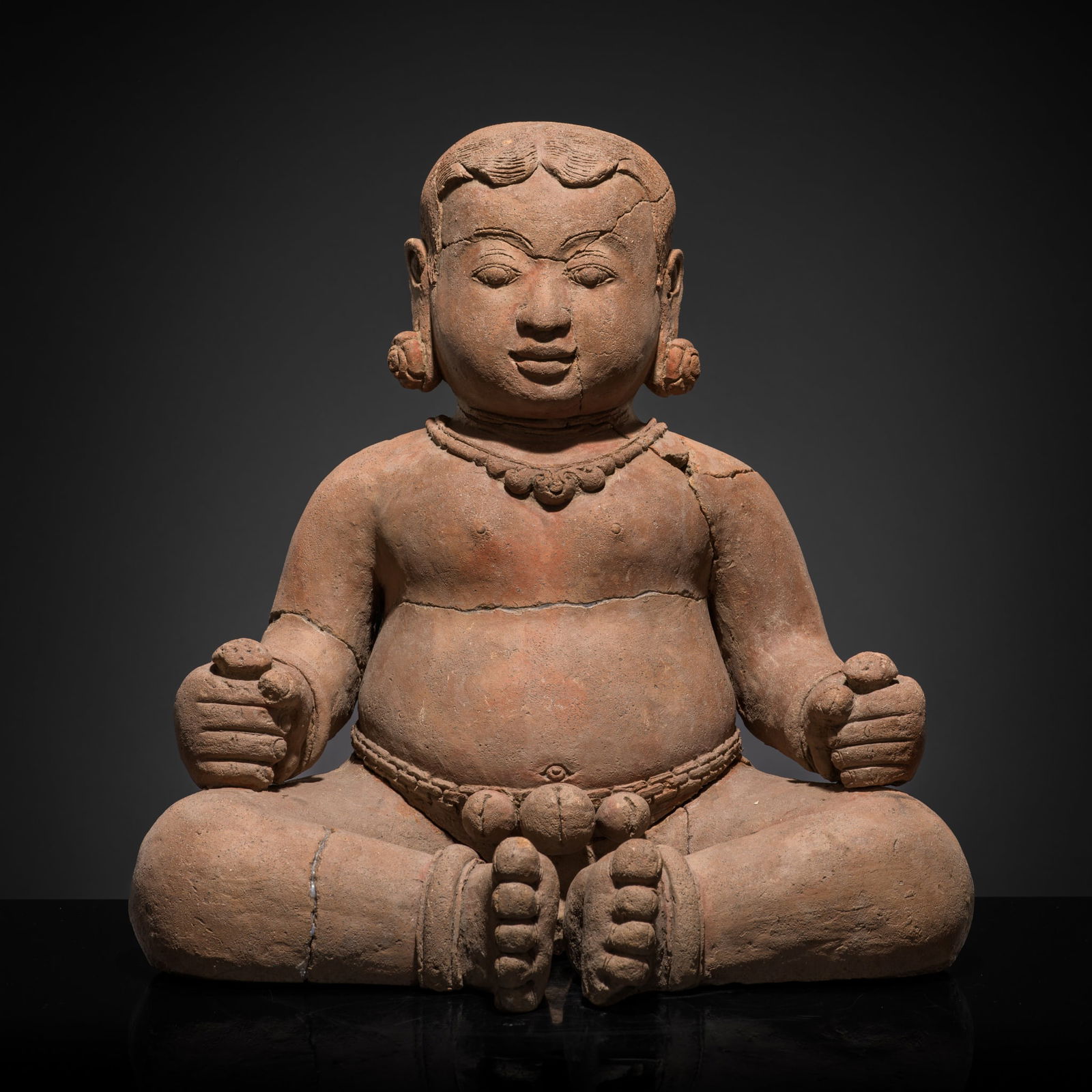 A MAJAPAHIT TERRACOTTA FIGURE OF A YOUNG NOBLE BOY: A MAJAPAHIT TERRACOTTA FIGURE OF A YOUNG NOBLE BOY This lot is from a single owner collection and is therefore offered without reserve Published: Editor Paolo Bertuzzi