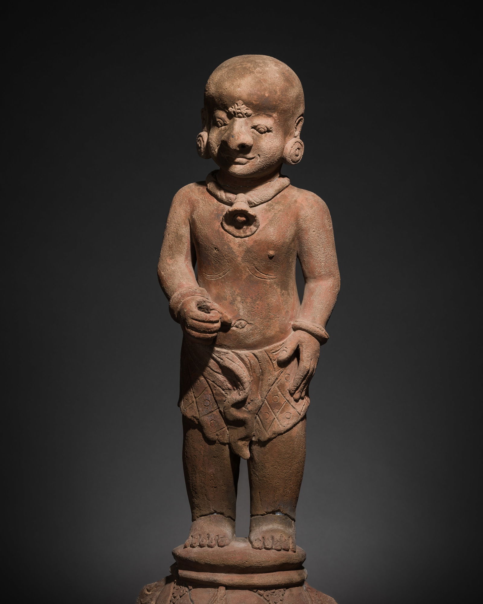 A MAJAPAHIT TERRACOTTA FIGURE OF A PUNAKAWAN, ROYAL SERVANT (1 of 13)