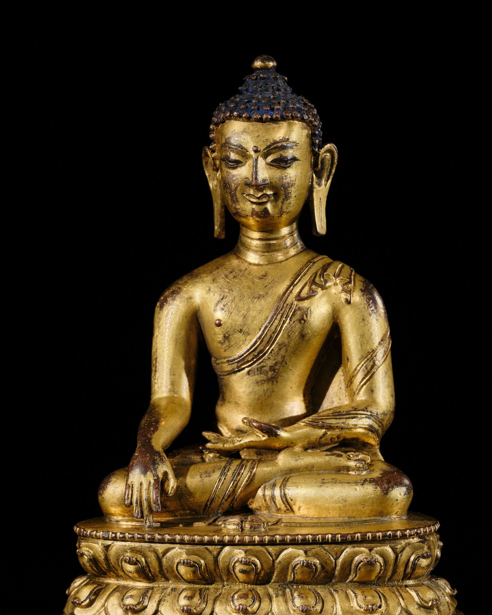 A GILT COPPER ALLOY FIGURE OF BUDDHA VAJRASANA, TIBET, 15TH CENTURY (1 of 13)