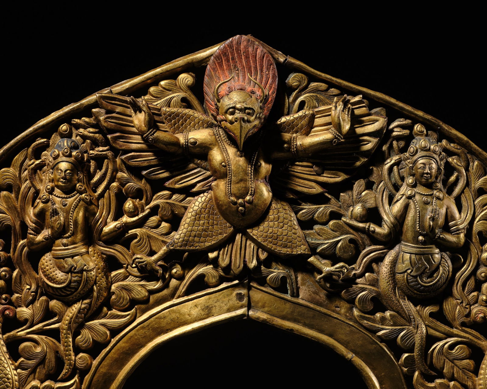 A LARGE GILT COPPER-ALLOY OPENWORK TORANA, NEPAL, 17TH-18TH CENTURY (1 of 16)