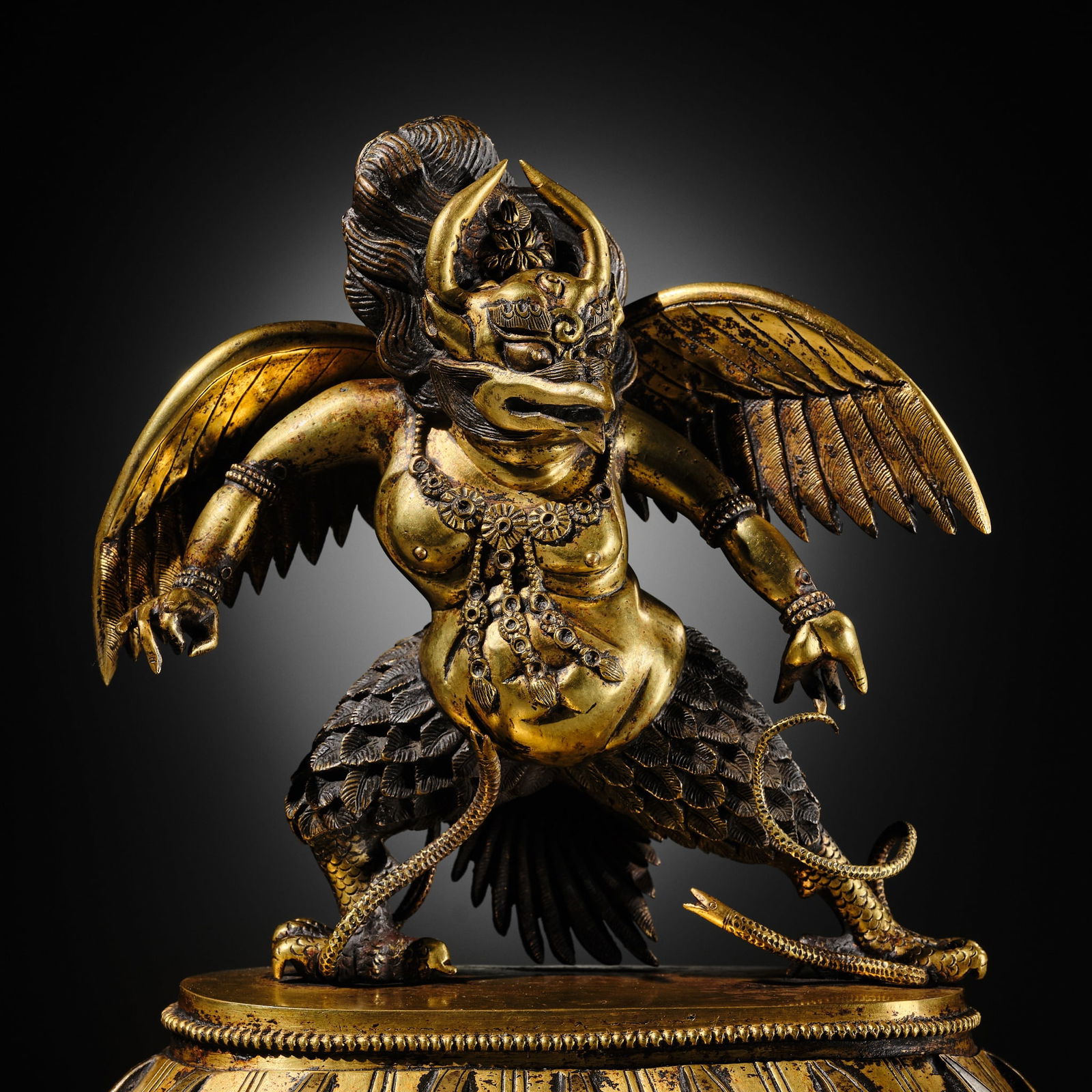 A SUPERB GILT BRONZE FIGURE OF GARUDA, TIBETAN-CHINESE, 17TH-18TH CENTURY: A SUPERB GILT BRONZE FIGURE OF GARUDA, TIBETAN-CHINESE, 17TH-18TH CENTURY Expert's note: This remarkable sculpture, distinguished by its commanding presence and bold modeling, adheres closely to estab