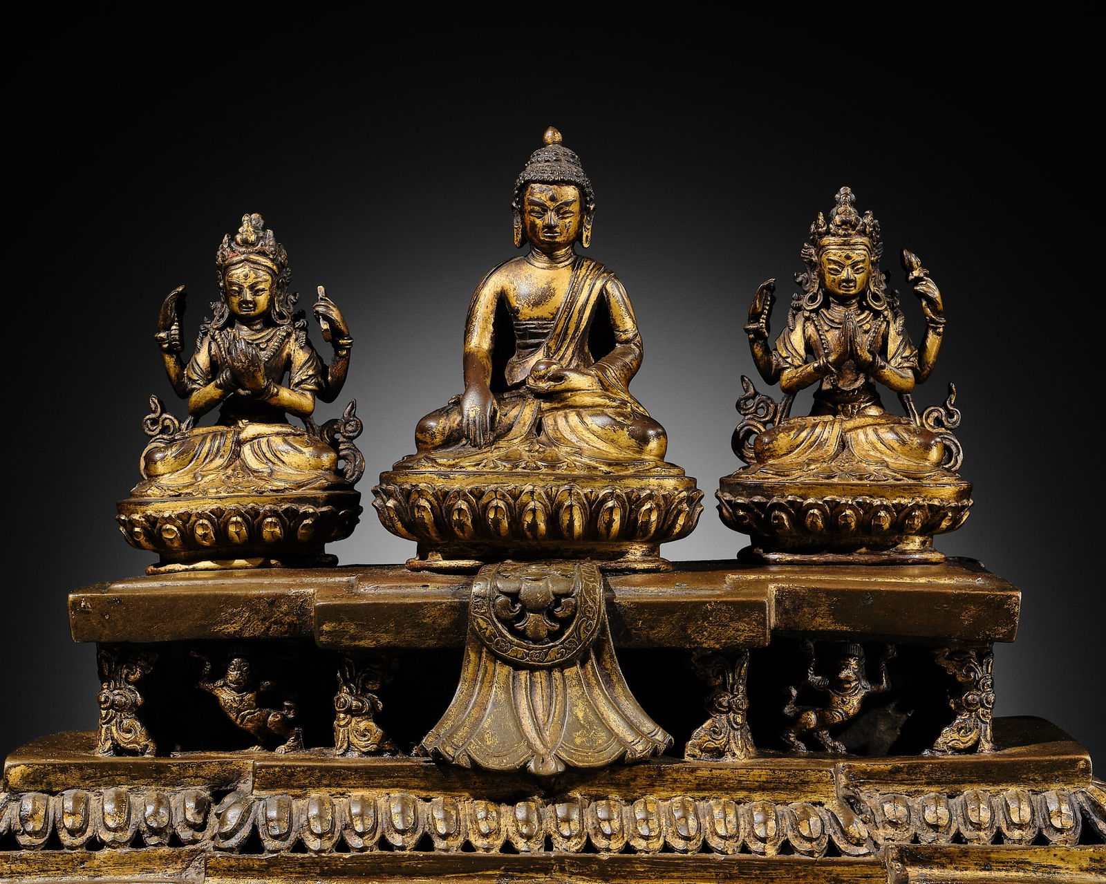 A GILT-BRONZE BUDDHA SHAKYAMUNI TRIAD, NEPAL, 18TH CENTURY (1 of 17)